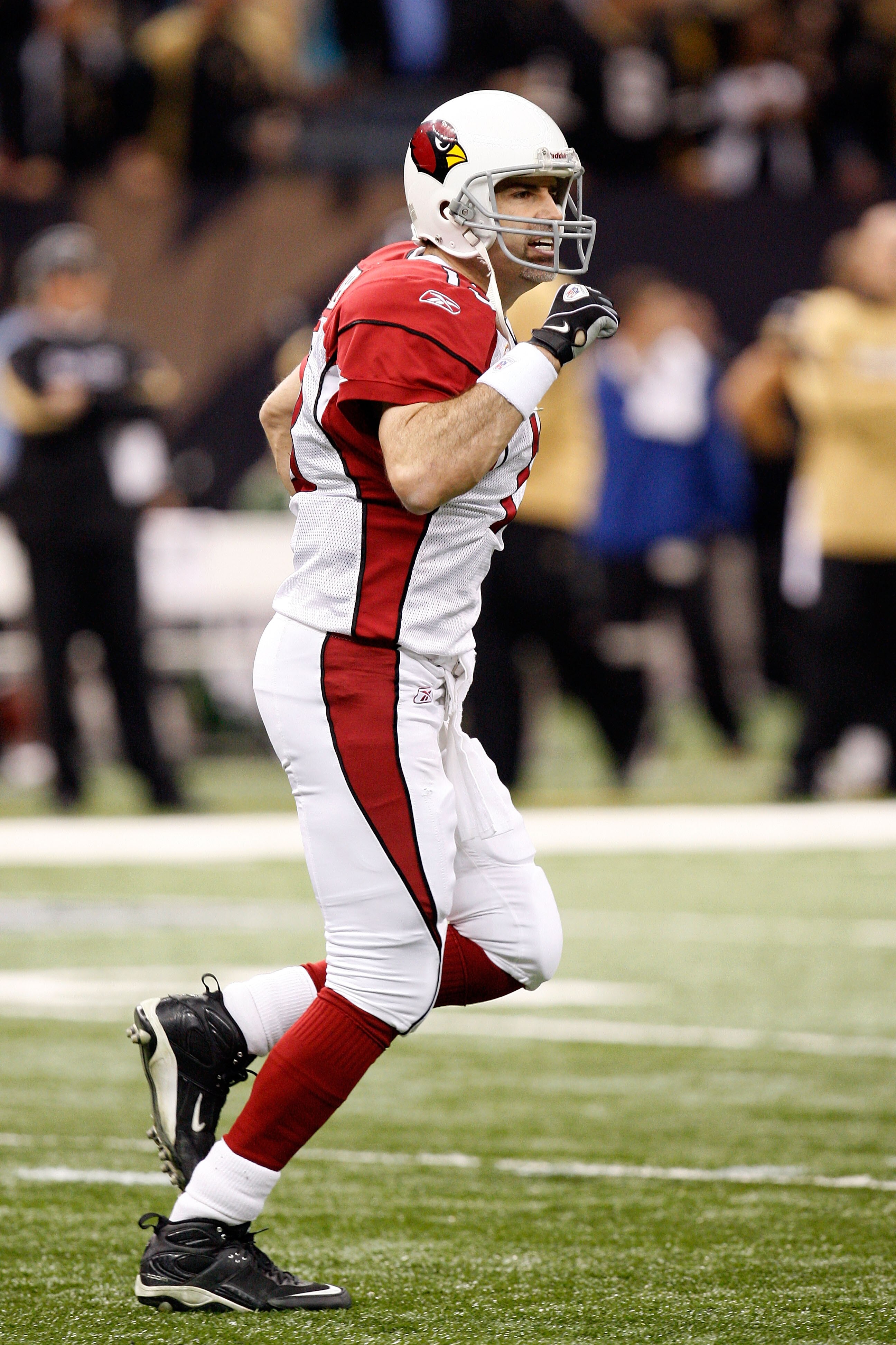NEW ORLEANS - JANUARY 16: Kurt Warner #13 of the Arizona Cardinals reacts after Tim Hightower scored a 70 yard rushing touchdown in the first quarter against the New Orleans Saints during the NFC Divisional Playoff Game at Louisana Superdome on January 1 NEW ORLEANS - JANUARY 16: Kurt Warner #13 of the Arizona Cardinals reacts after Tim Hightower scored a 70 yard rushing touchdown in the first quarter against the New Orleans Saints during the NFC Divisional Playoff Game at Louisana Superdome on January 1