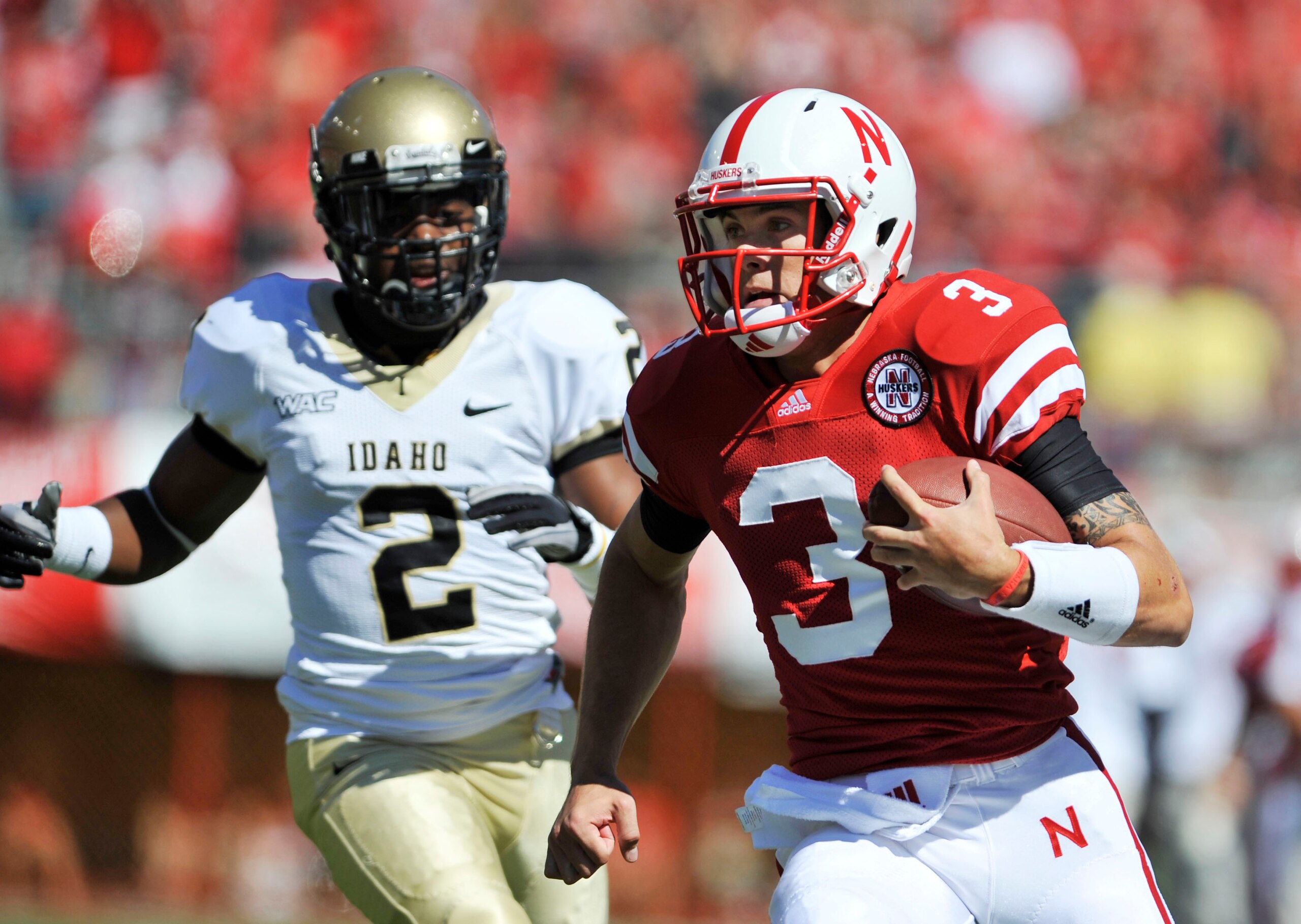 LINCOLN, NEBRASKA - SEPTEMBER 11: Nebraska Cornhuskers quarterback Taylor Martinez #3 runs for a touchdown past Idaho Vandals cornerback Kenneth Patten #2 during first half action of their game at Memorial Stadium on September 4, 2010 in Lincoln, Nebraska