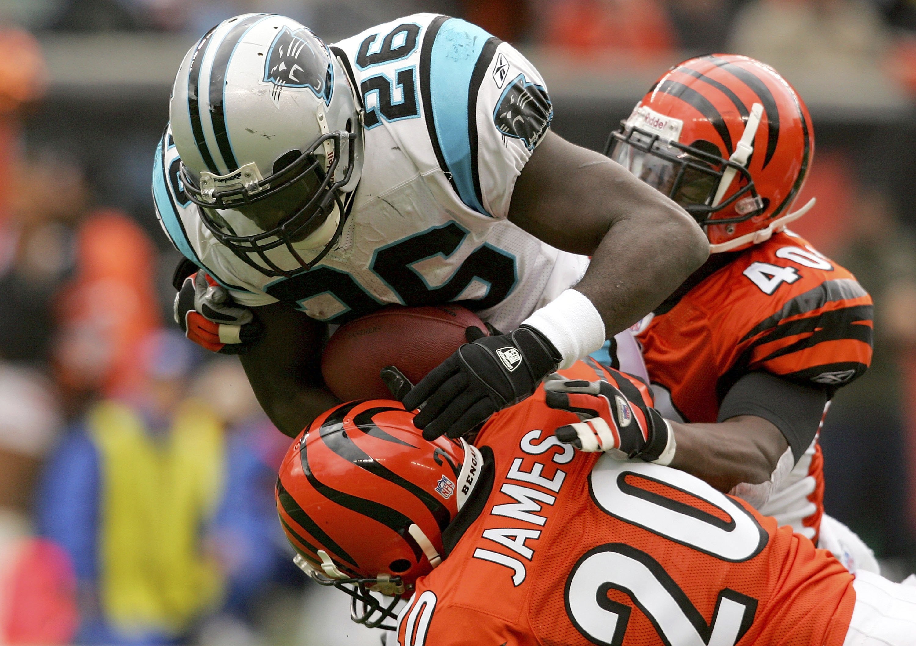 CINCINNATI - OCTOBER 22: DeShaun Foster #26 of the Carolina Panthers is brought down by Tory James #20 and Madieu Williams #40 of the Cincinnati Bengals October 22, 2006 at Paul Brown Stadium in Cincinnati, Ohio. (Photo by Matthew Stockman/Getty Images) CINCINNATI - OCTOBER 22: DeShaun Foster #26 of the Carolina Panthers is brought down by Tory James #20 and Madieu Williams #40 of the Cincinnati Bengals October 22, 2006 at Paul Brown Stadium in Cincinnati, Ohio. (Photo by Matthew Stockman/Getty Images)