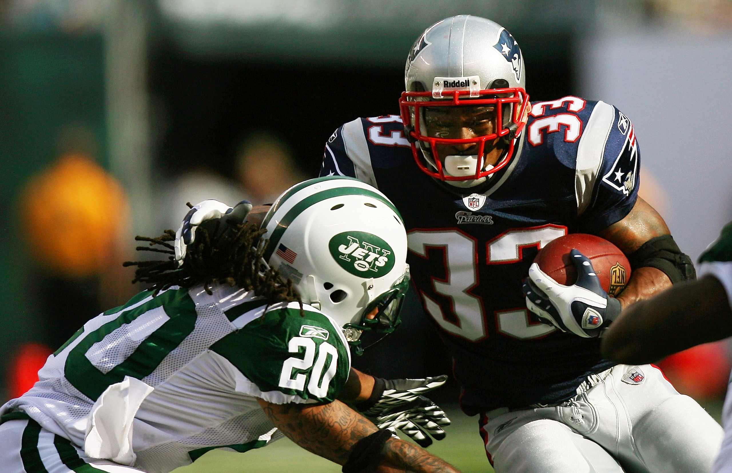 EAST RUTHERFORD, NJ - SEPTEMBER 19: Kyle Wilson #20 of the New York Jets attempts to tackle Kevin Faulk #33 of the New England Patriots during the first quarter at the New Meadowlands Stadium on September 19, 2010 in East Rutherford, New Jersey. (Photo EAST RUTHERFORD, NJ - SEPTEMBER 19: Kyle Wilson #20 of the New York Jets attempts to tackle Kevin Faulk #33 of the New England Patriots during the first quarter at the New Meadowlands Stadium on September 19, 2010 in East Rutherford, New Jersey. (Photo