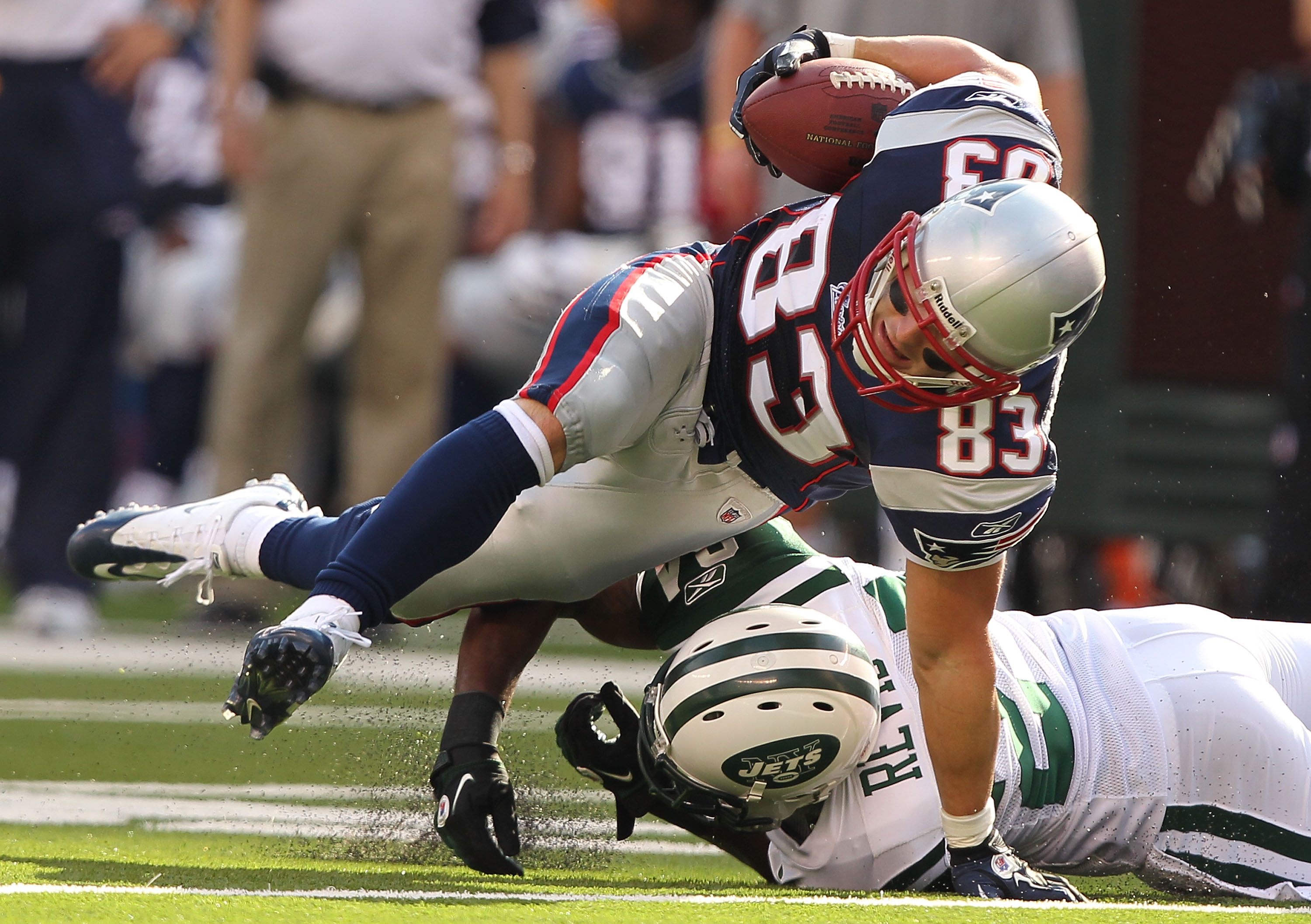 EAST RUTHERFORD, NJ - SEPTEMBER 19:  Darrelle Revis #24 of the New York Jets tackles Wes Welker #83 of the New England Patriots during their  game on September 19, 2010 at the New Meadowlands Stadium  in East Rutherford, New Jersey.  (Photo by Al Bello/Ge