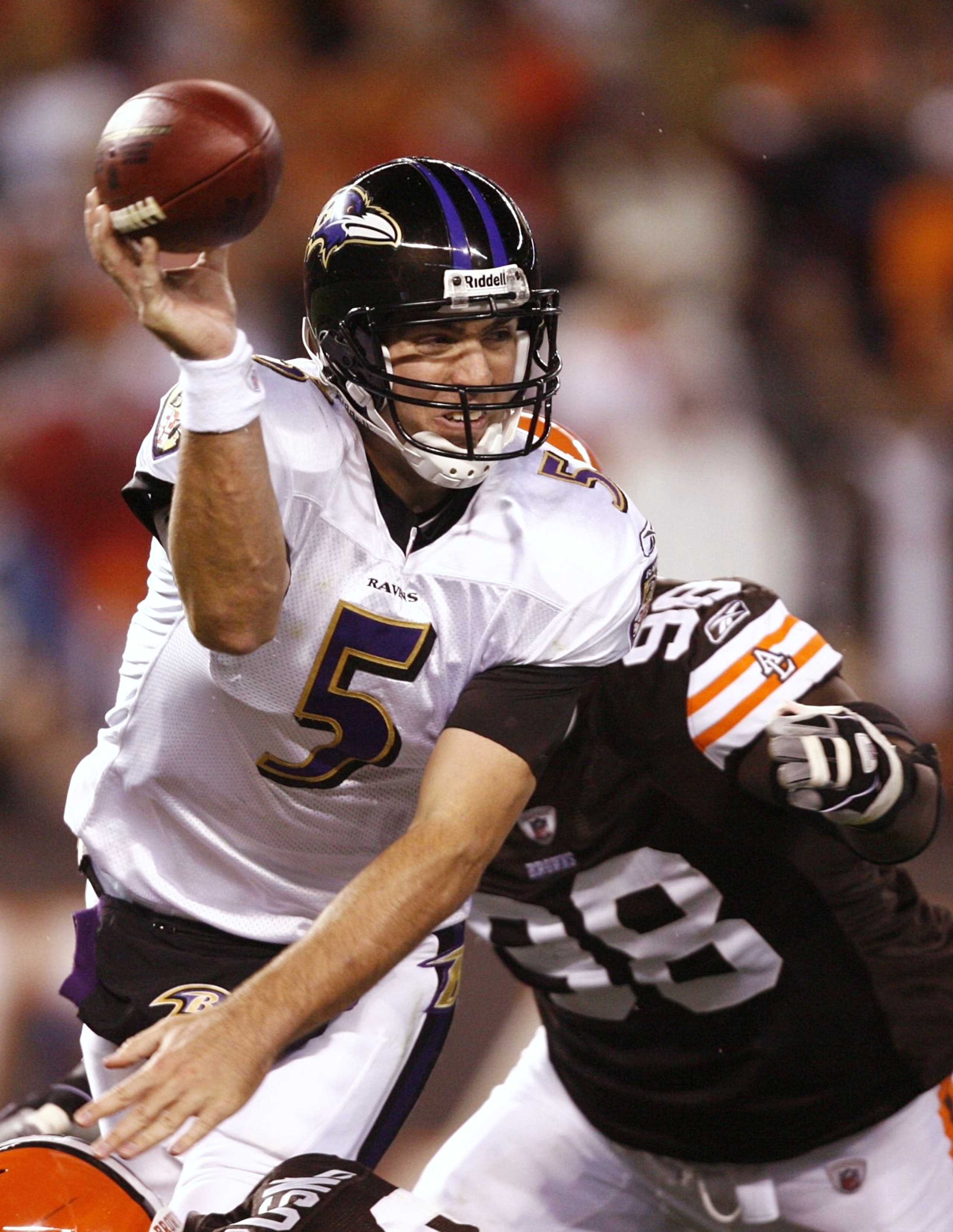CLEVELAND - NOVEMBER 16: Joe Flacco #5 of the Baltimore Ravens attempts to throw a pass in the second quarter as he is pressured by Robaire Smith #98 of the Cleveland Browns at Cleveland Browns Stadium on November 16, 2009 in Cleveland, Ohio.  (Photo by M