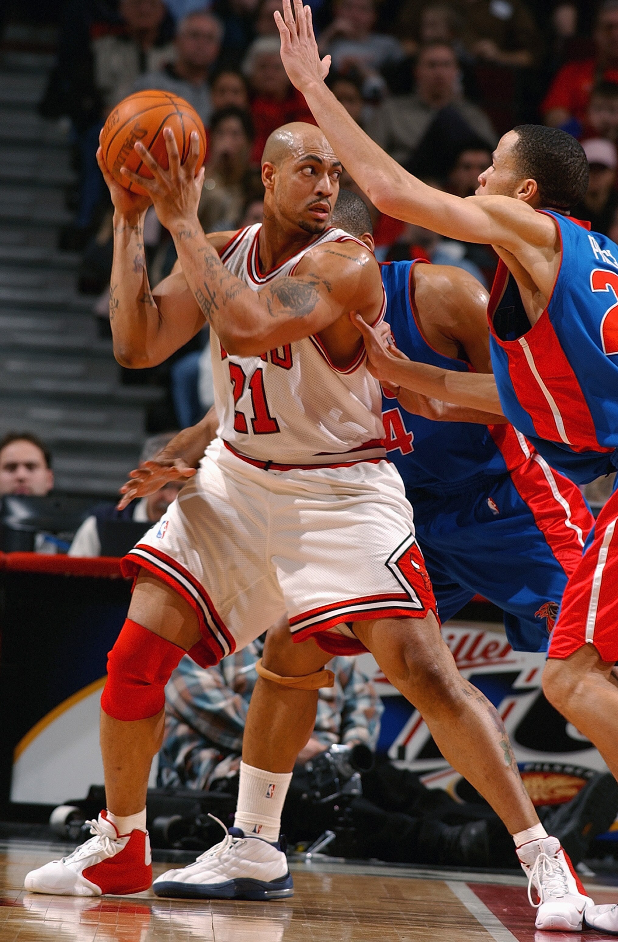 CHICAGO - FEBRUARY 25:  Marcus Fizer #21 of the Chicago Bulls posts up Tayshaun Prince #22 of the Detroit Pistons during a game on February 25, 2004 at the United Center in Chicago, Illinois. The Pistons won 107-88. NOTE TO USER: User expressly acknowledg