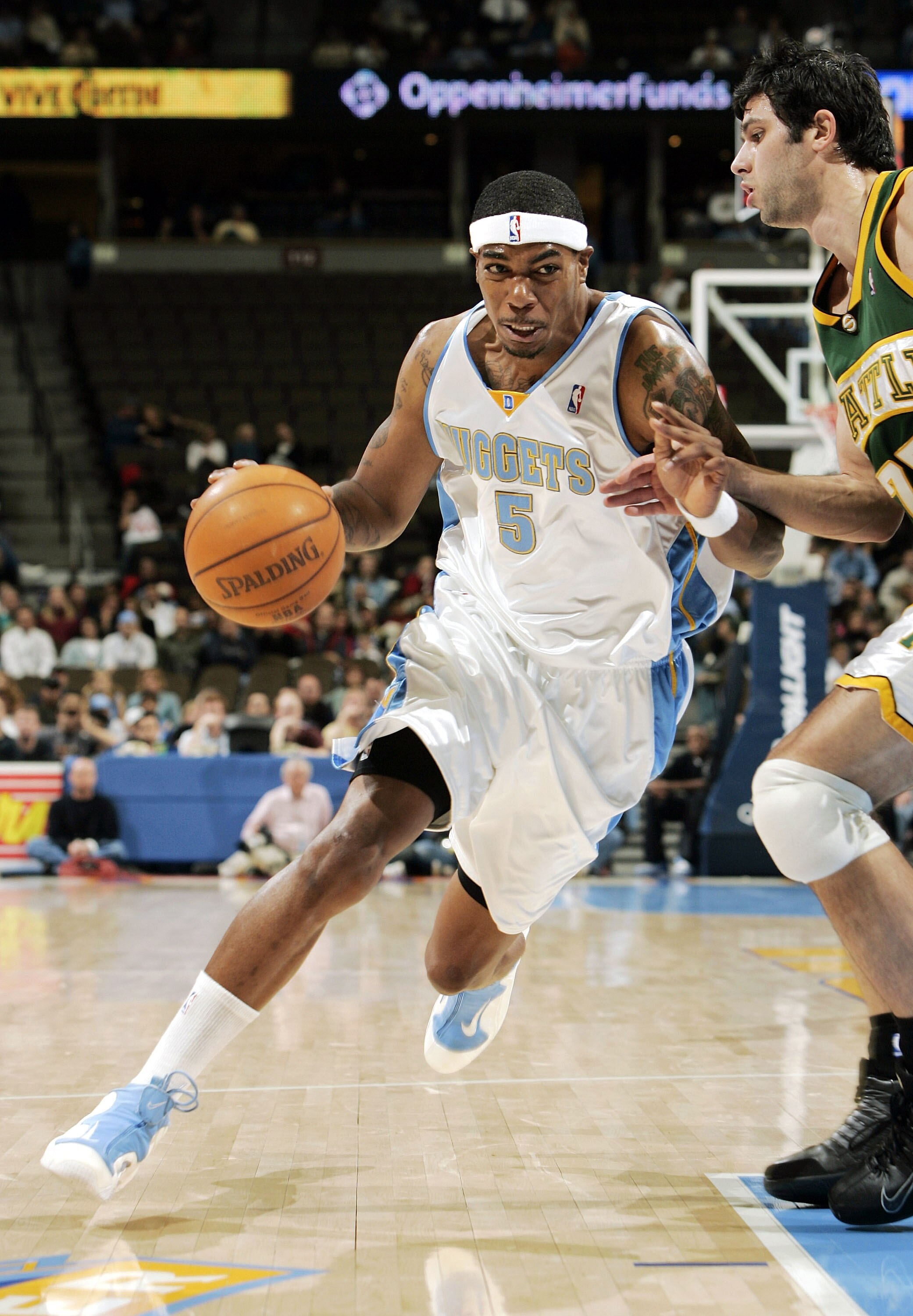 DENVER - NOVEMBER 9:  Rodney White #5 of the Denver Nuggets drives to the basket against Vladimir Radmanovic #77 of the Seattle SuperSonics in the first half at the Pepsi Center on November 9, 2004 in Denver, Colorado.  NOTE TO USER: User expressly acknow