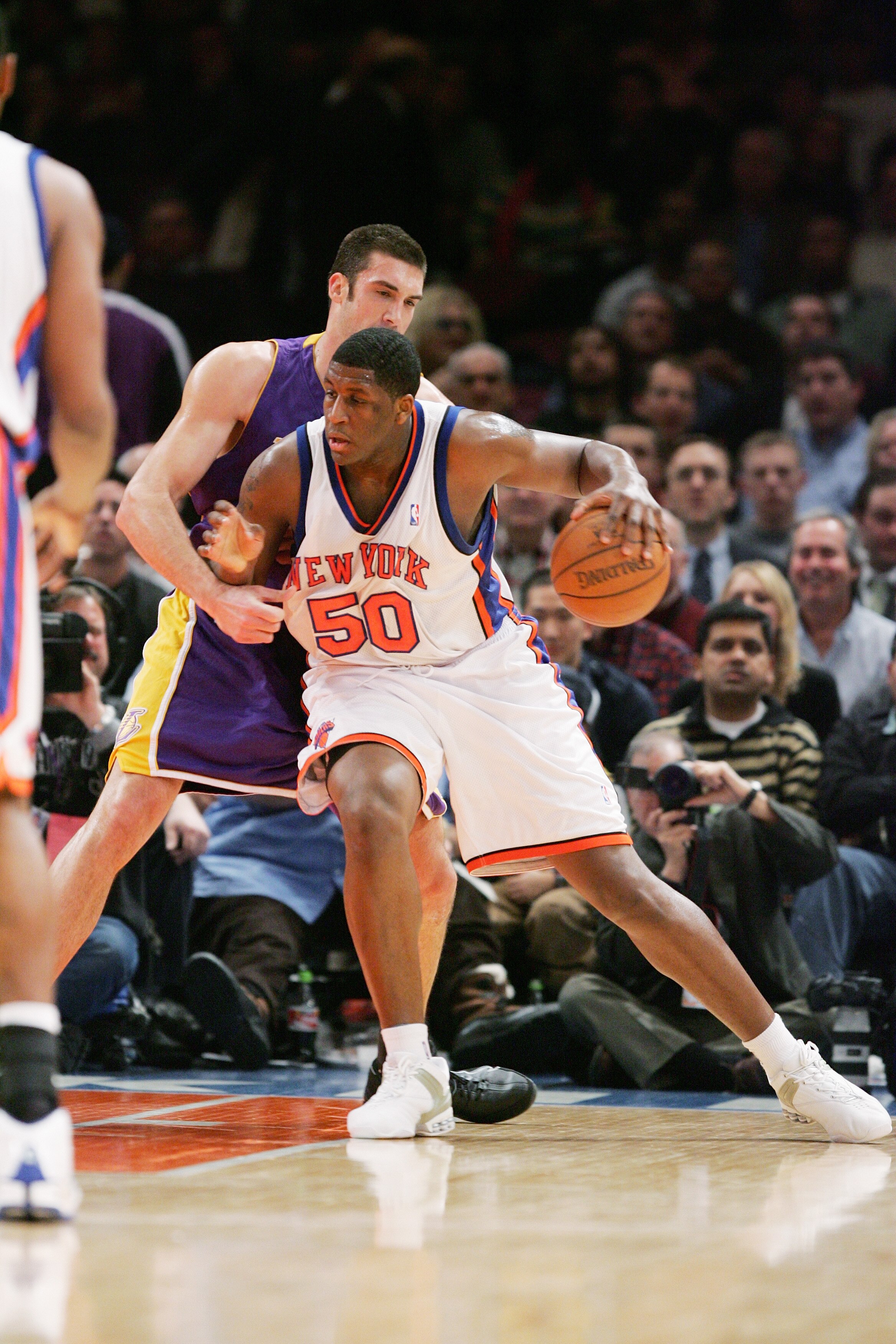 NEW YORK - FEBRUARY 28:  Michael Sweetney #50 of the New York Knicks moves the ball against Chris Mihm #31 of the Los Angeles Lakers during the game on February 28, 2005 at Madison Square Garden in New York City.  The Knicks won 117-115.  NOTE TO USER:  U