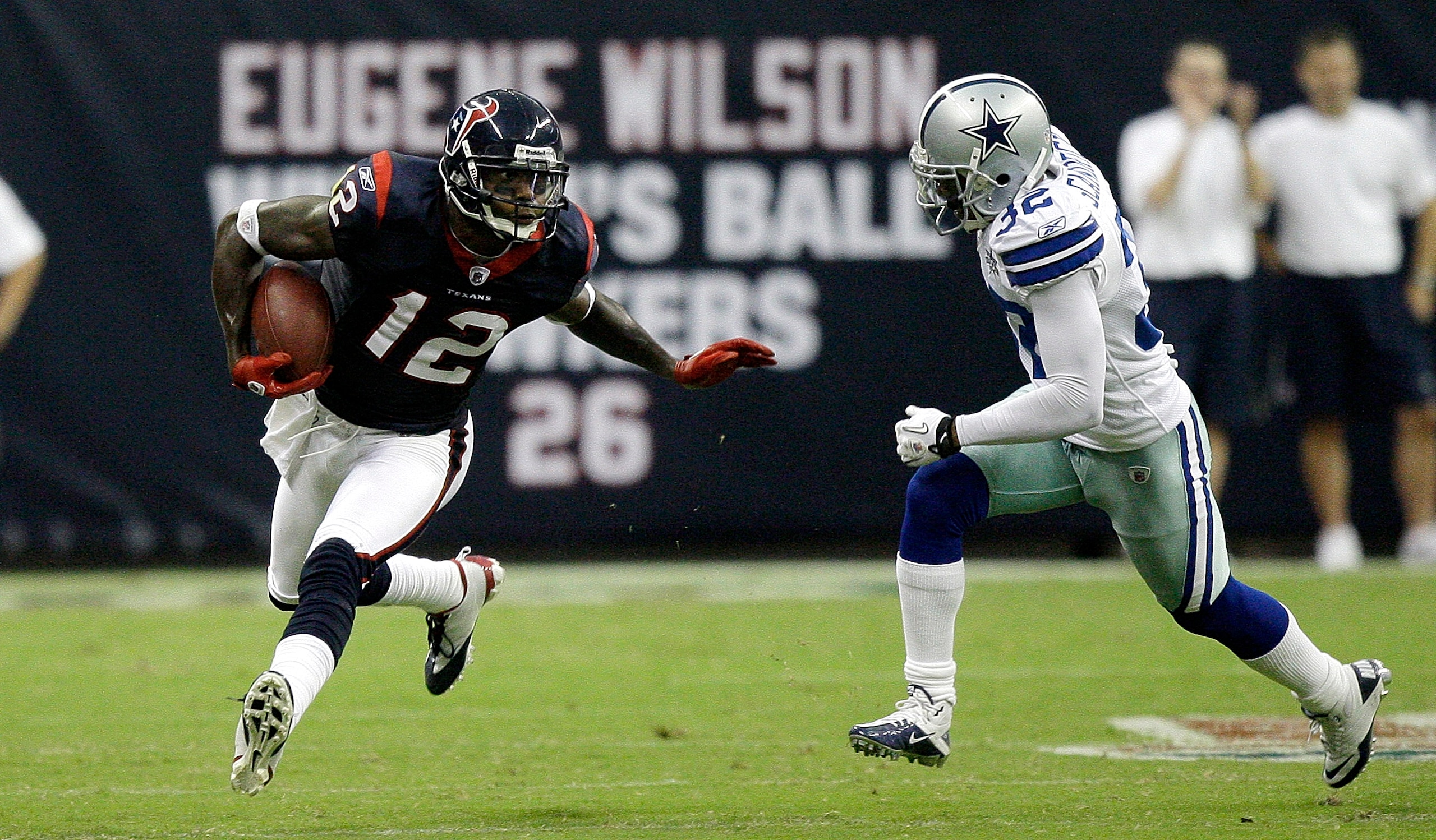 HOUSTON - AUGUST 28: Wide receiver Jacoby Jones #12 of the Houston Texans fends off Orlando Scandrick #32 in the first quarter at Reliant Stadium on August 28, 2010 in Houston, Texas. (Photo by Bob Levey/Getty Images)