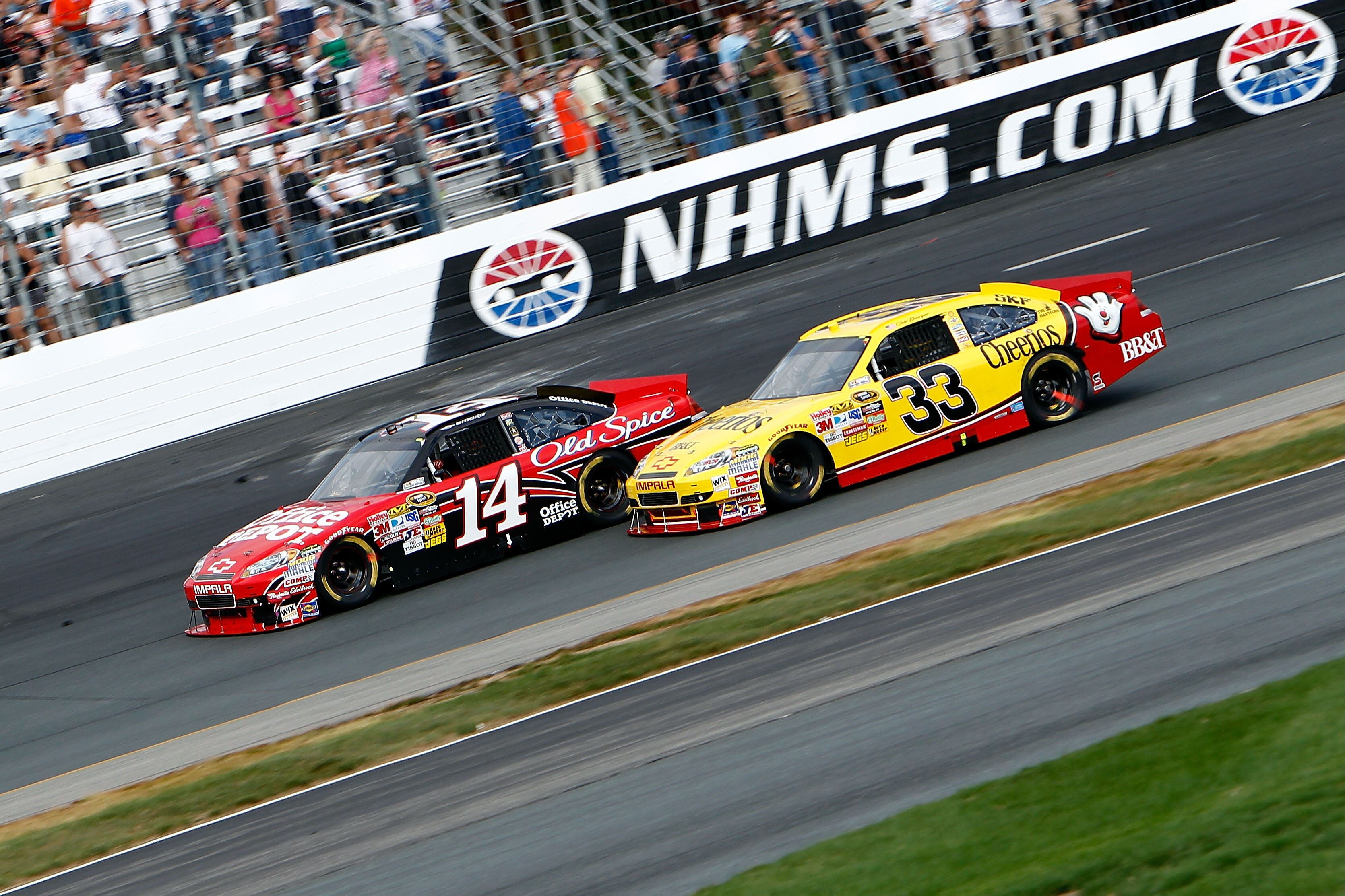 LOUDON, NH - SEPTEMBER 19: Clint Bowyer, driver of the #33 Cheerios/Hamburger Helper Chevrolet races with Tony Stewart, driver of the #14 Office Depot/Old Spice Chevrolet  during the NASCAR Sprint Cup Series Sylvania 300 at New Hampshire Motor Speedway on