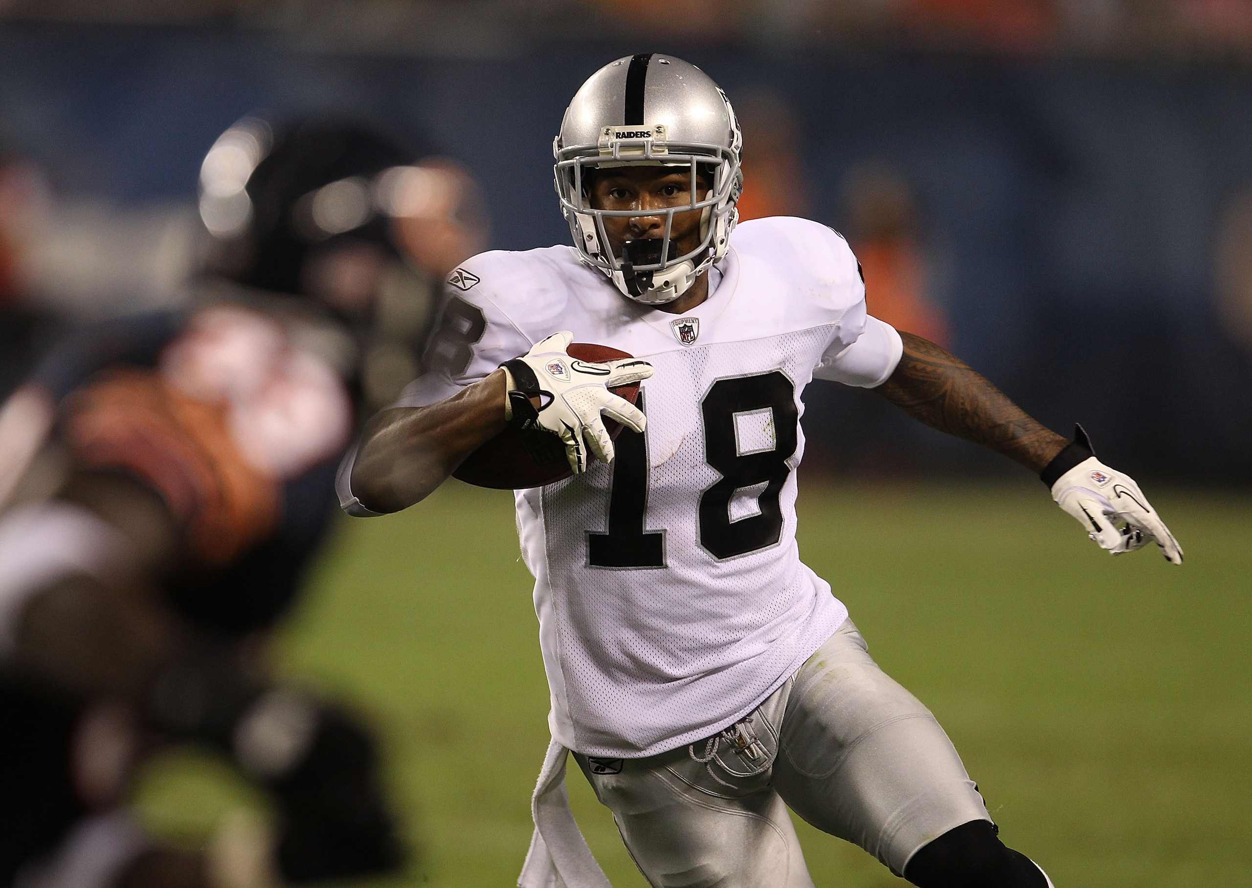 CHICAGO - AUGUST 21: Louis Murphy #18 of the Oakland Raiders runs for yardage as Charles Tillman #33 of the Chicago Bears closes in during a preseason game at Soldier Field on August 21, 2010 in Chicago, Illinois. (Photo by Jonathan Daniel/Getty Images)