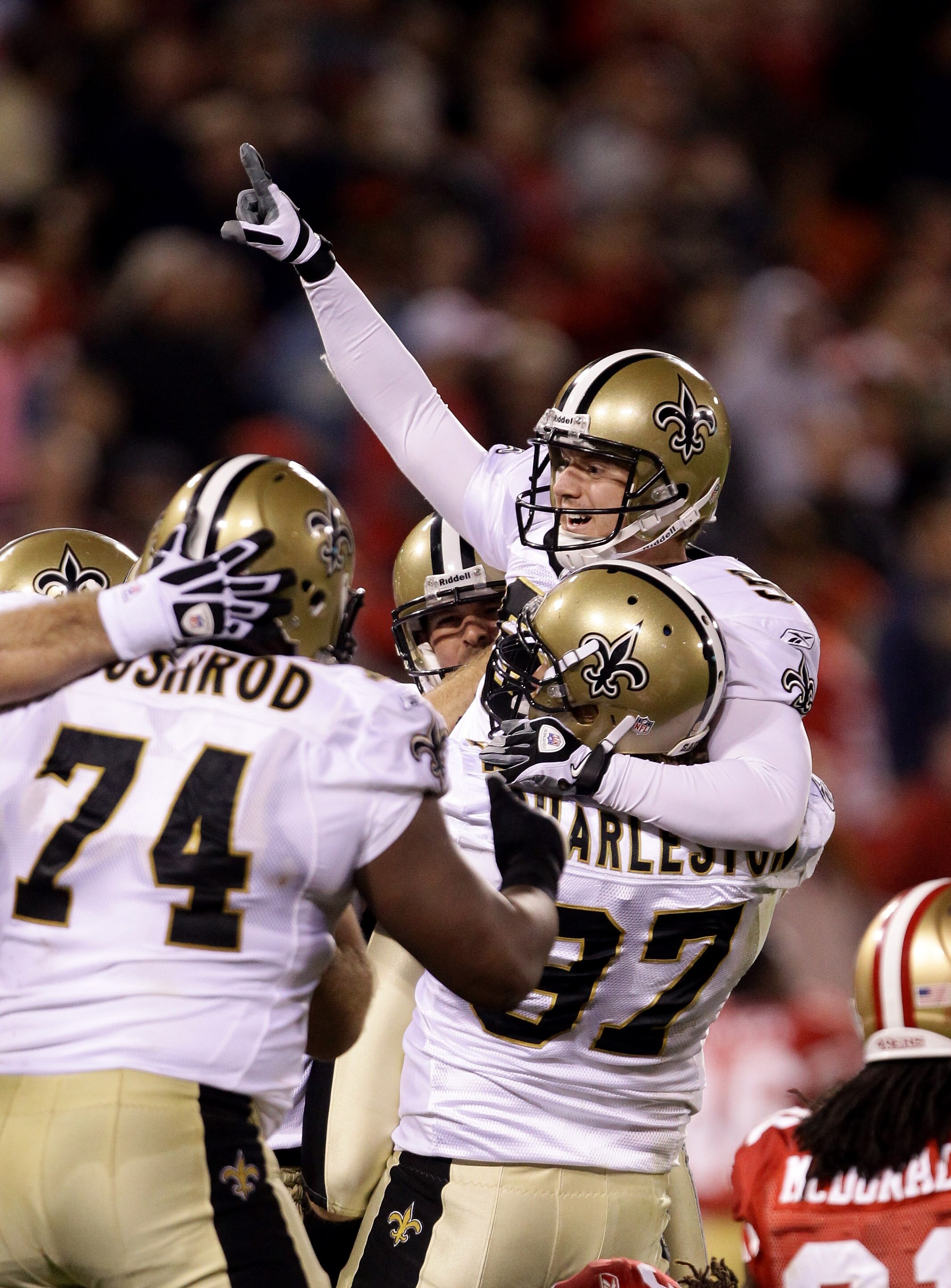 SAN FRANCISCO - SEPTEMBER 20:  Garrett Hartley #5 of the New Orleans Saints is lifted in the air by Jeff Charleston #97 after Hartley kicked the game winning field goal against the San Francisco 49ers at Candlestick Park on September 20, 2010 in San Franc