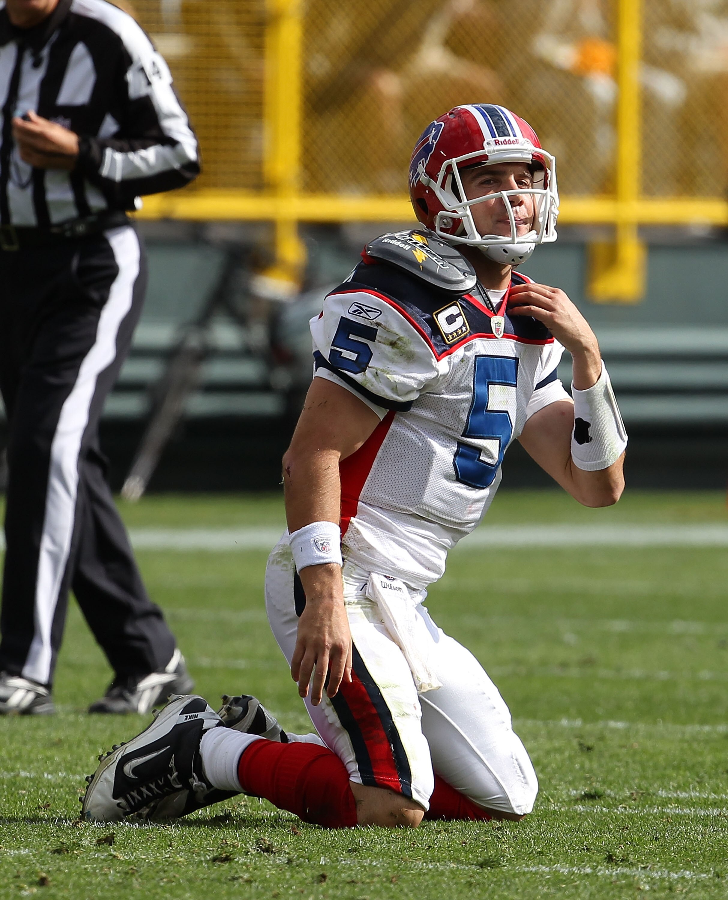 GREEN BAY, WI - SEPTEMBER 19: Trent Edwards #5 of the Buffalo Bills tries to adjust his shoulder pads after being knocked to the ground by a member of the Green Bay Packers defense at Lambeau Field on September 19, 2010 in Green Bay, Wisconsin. The Packer