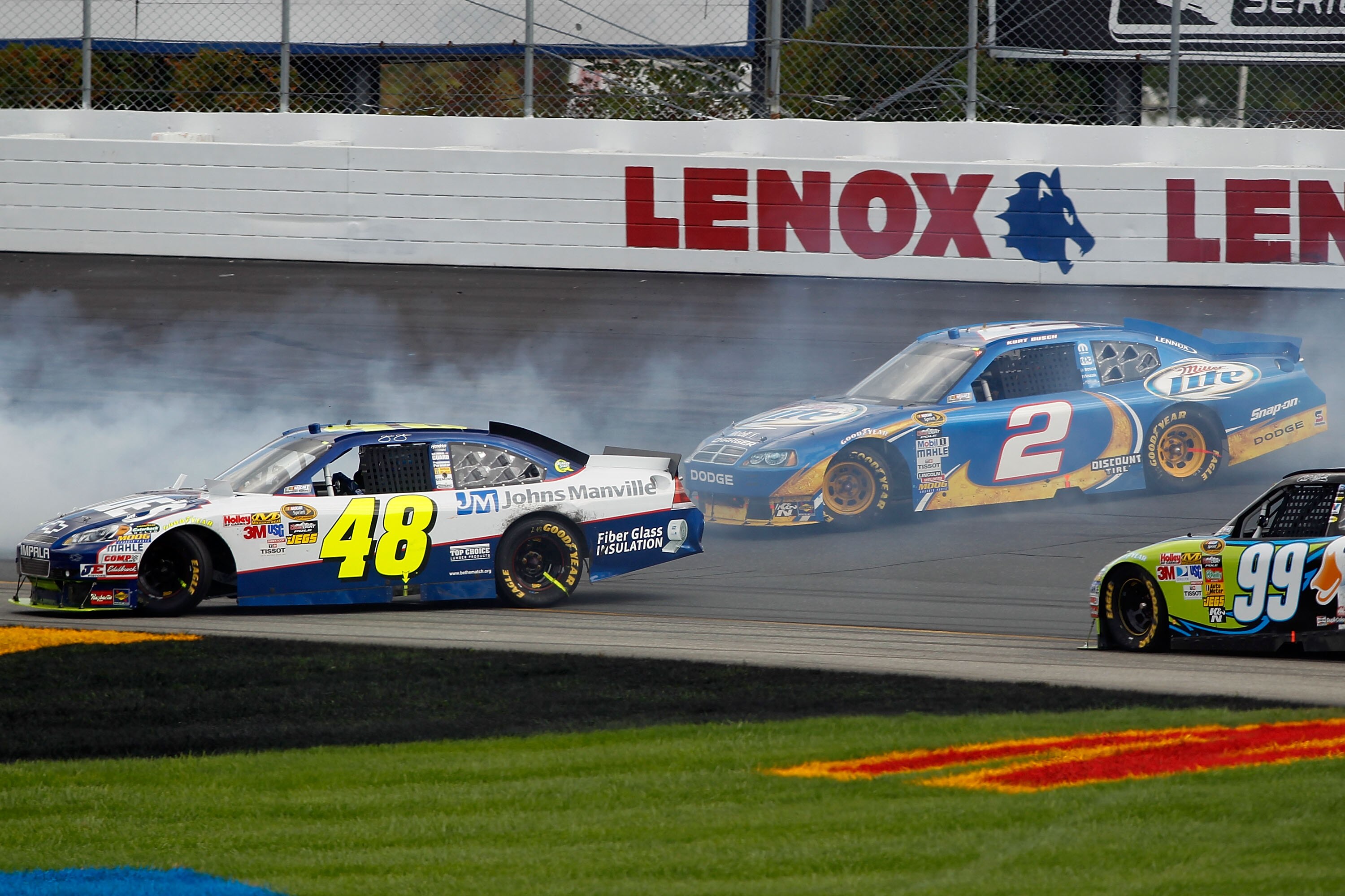 LOUDON, NH - SEPTEMBER 19:  Jimmie Johnson, driver of the #48 Lowe's/Johns Manville Chevrolet, and Kurt Busch, driver of the #2 Miller Lite Dodge, spin in turn 2 during the NASCAR Sprint Cup Series Sylvania 300 at New Hampshire Motor Speedway on September