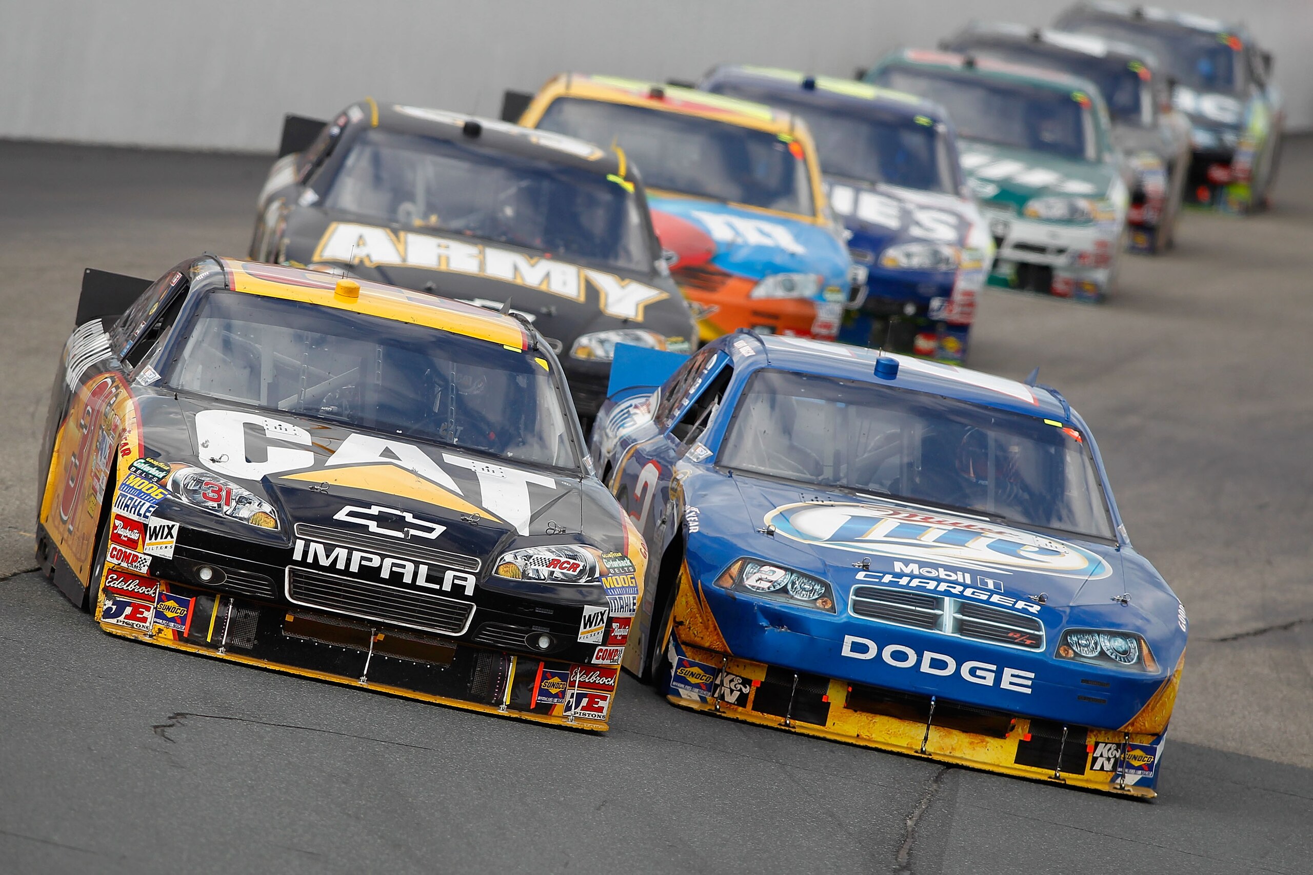 LOUDON, NH - SEPTEMBER 19:  Jeff Burton, driver of the #31 Caterpillar Chevrolet, and Kurt Busch, driver of the #2 Miller Lite Dodge, lead a pack of cars during the NASCAR Sprint Cup Series Sylvania 300 at New Hampshire Motor Speedway on September 19, 201