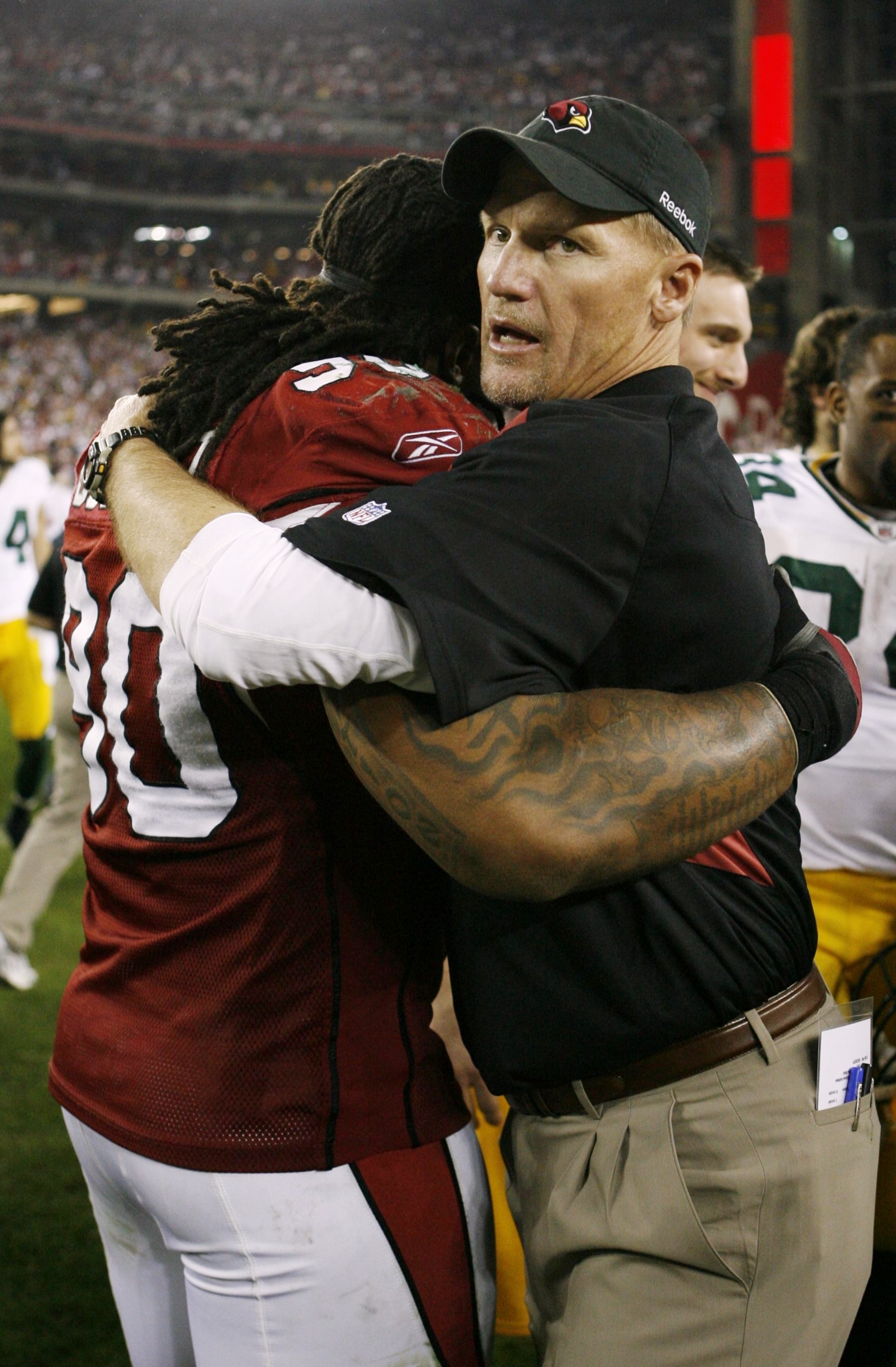 GLENDALE, AZ - JANUARY 10:  Head coach Ken Whisenhunt of the Arizona Cardinals hugs Darnell Dockett #90 after they won the 2010 NFC wild-card playoff game 51-45 against the Green Bay Packers in overtime at University of Phoenix Stadium on January 10, 2010