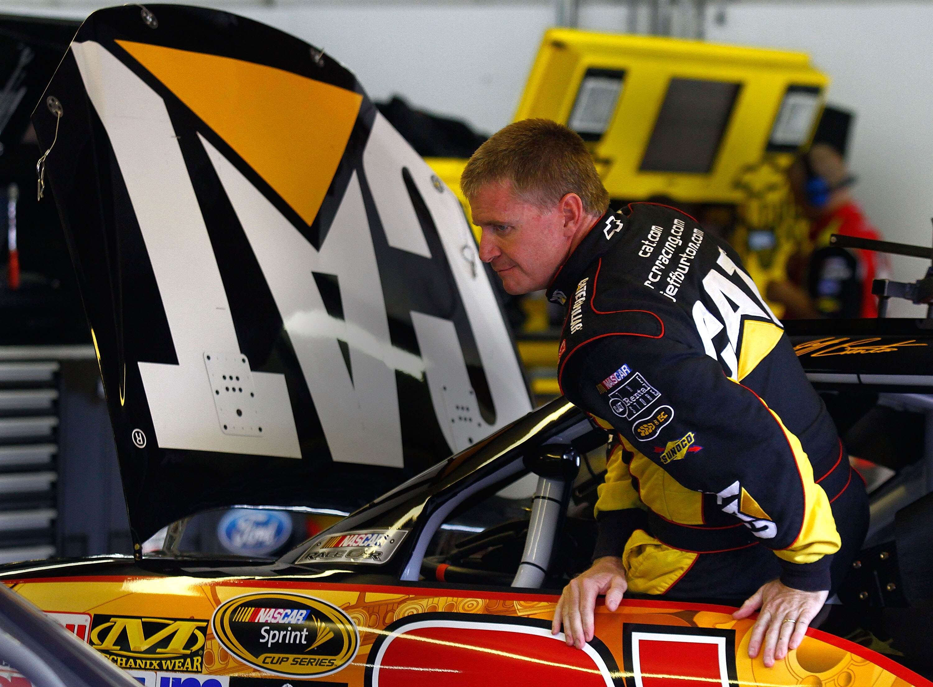 LOUDON, NH - SEPTEMBER 18:  Jeff Burton, driver of the #31 Caterpillar Chevrolet, climbs out of his car in the garage during practice for the NASCAR Sprint Cup Series Sylvania 300 at New Hampshire Motor Speedway on September 18, 2010 in Loudon, New Hampsh