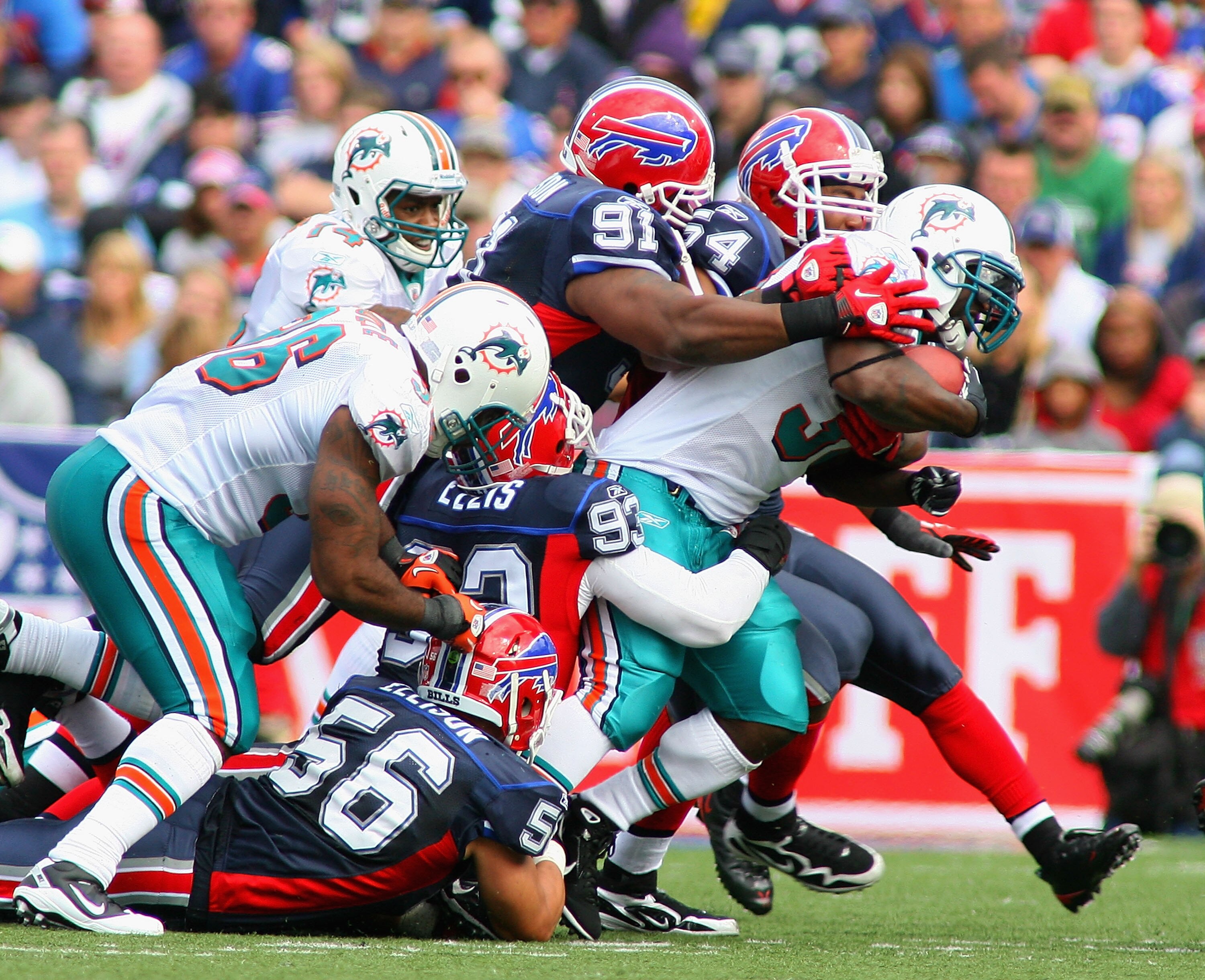 ORCHARD PARK, NY - SEPTEMBER 12: Ricky Williams #34 of the Miami Dolphins is tackled by the Buffalo Bills  defense during the NFL season opener at Ralph Wilson Stadium on September 12, 2010 in Orchard Park, New York. Miami won 15-10. (Photo by Rick Stewar