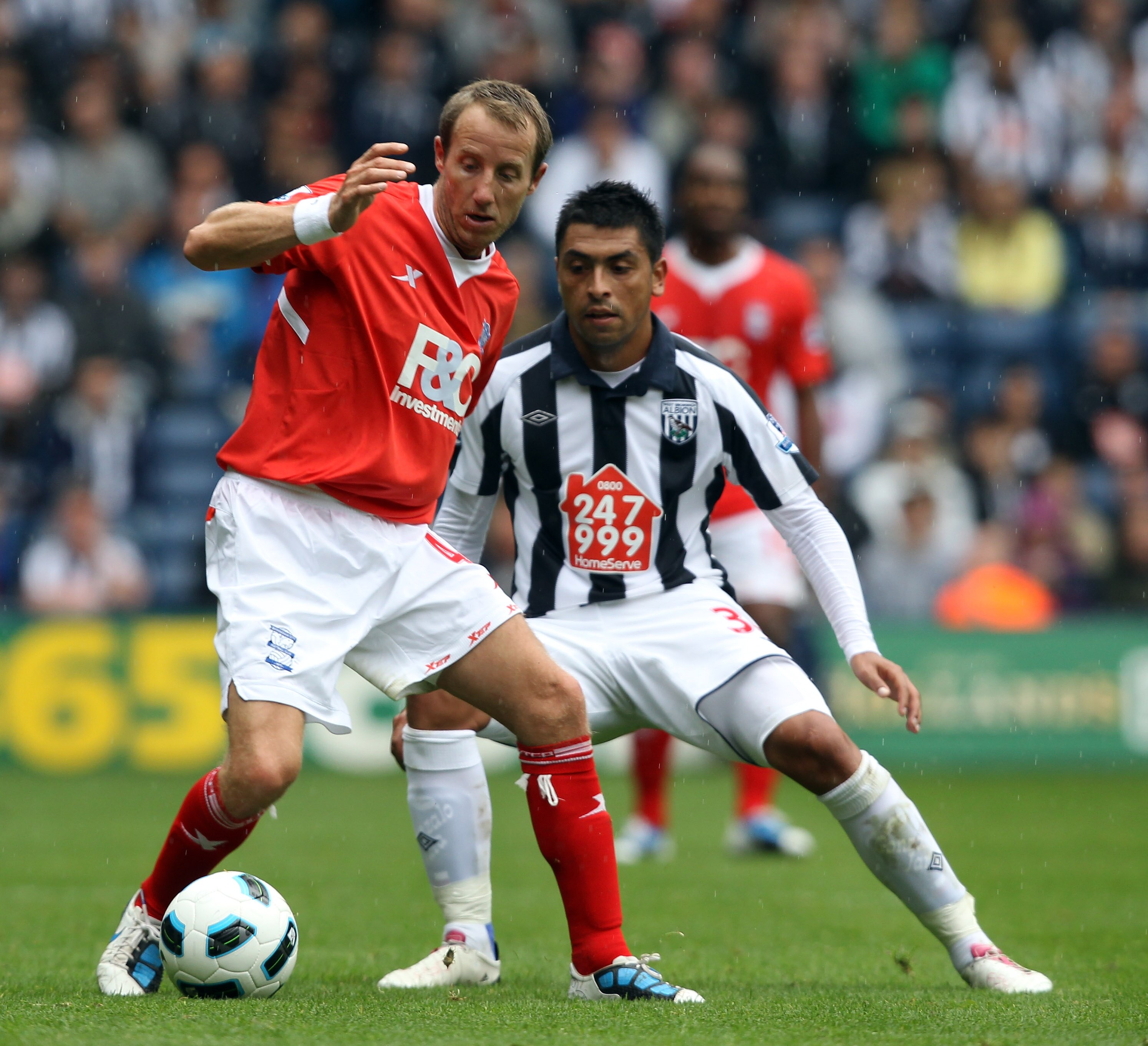 WEST BROMWICH, ENGLAND - SEPTEMBER 18:  Gonzalo Jara of West Brom is challenged by Lee Bowyer of Birmingham during the Barclays Premier League match between West Bromwich Albion and Birmingham City at The Hawthorns on September 18, 2010 in West Bromwich,