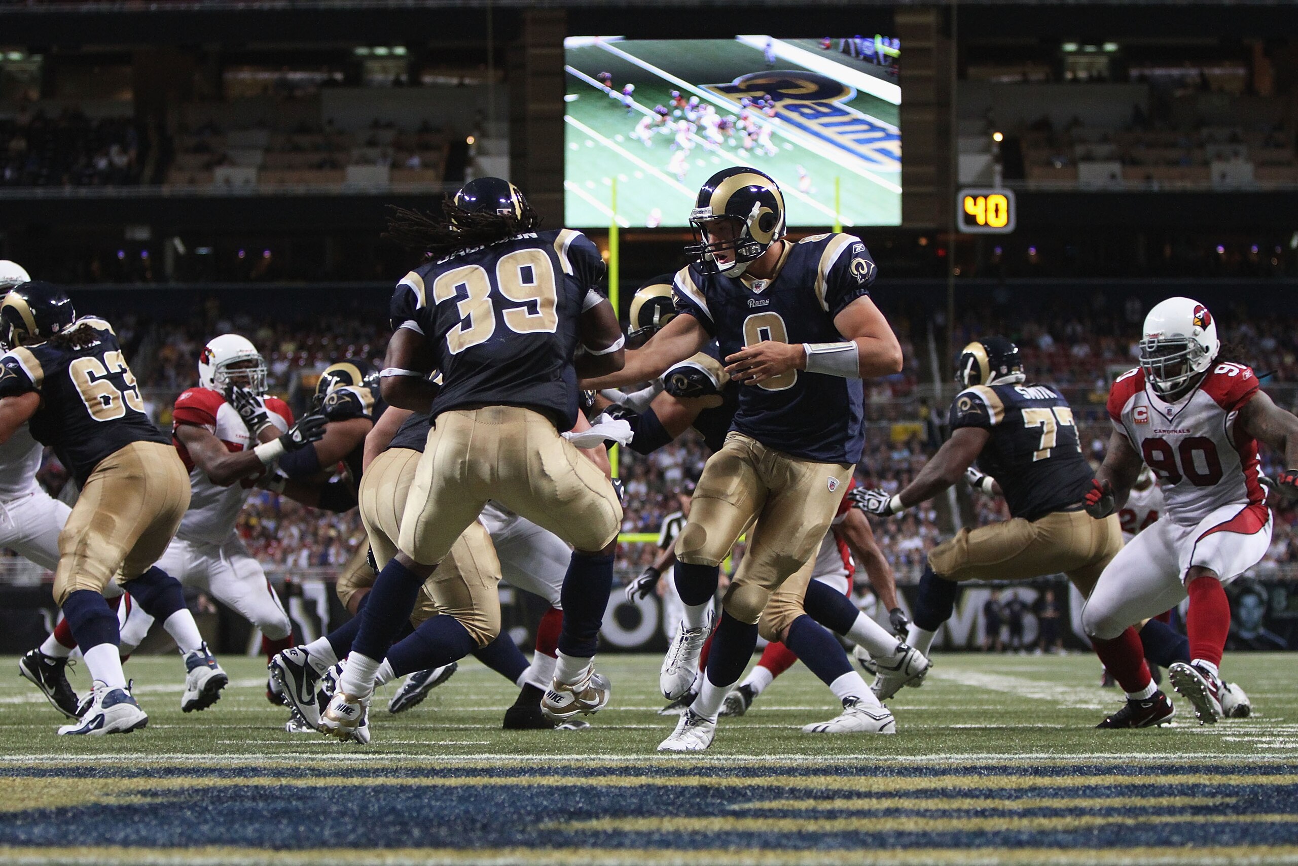 ST. LOUIS - SEPTEMBER 12: Sam Bradford #8 of the St. Louis Rams hands the ball off against the Arizona Cardinals during the NFL season opener at the Edward Jones Dome on September 12, 2010 in St. Louis, Missouri.  The Cardinals beat the Rams 17-13.  (Phot
