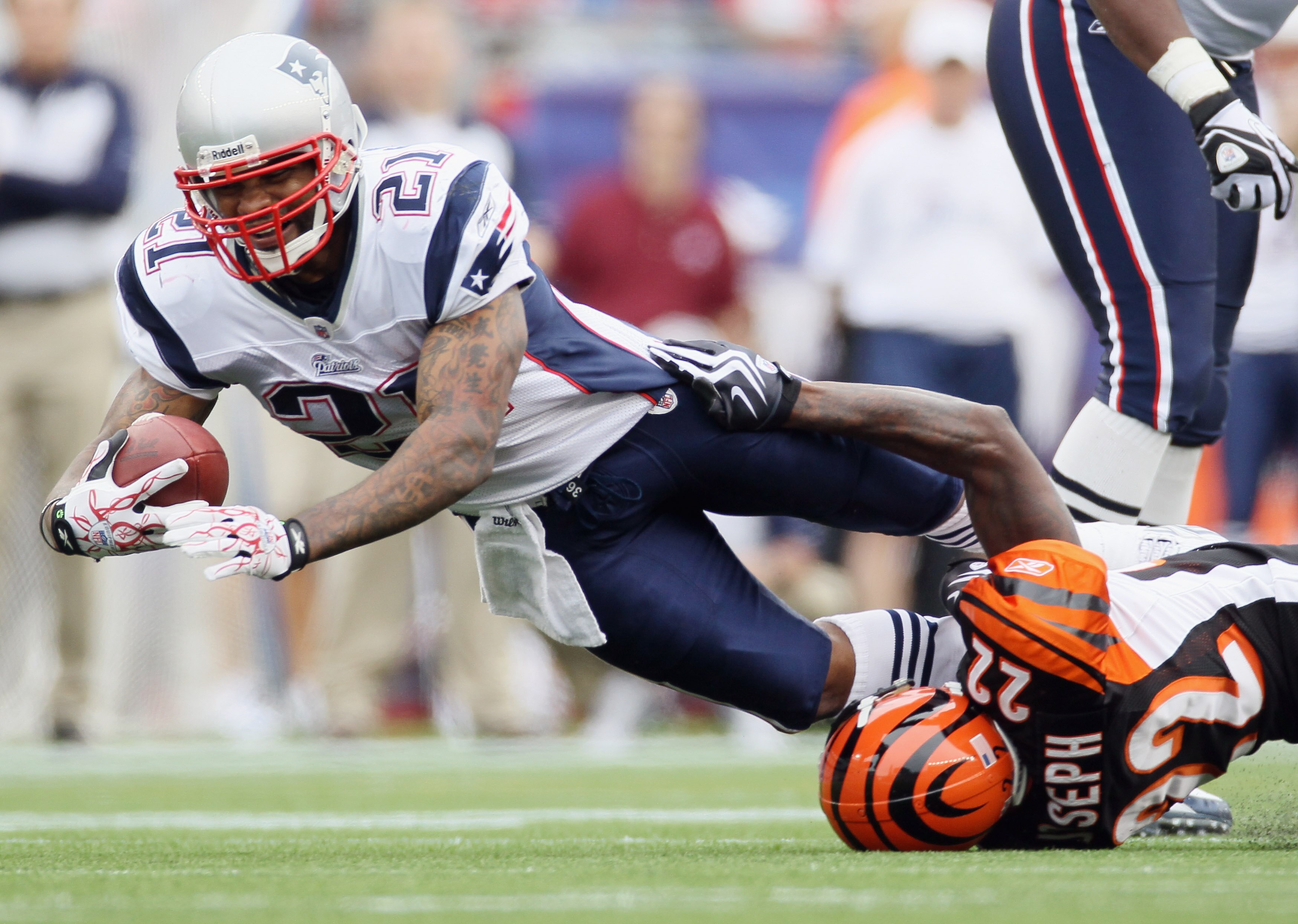 FOXBORO, MA - SEPTEMBER 12:  Fred Taylor #21 of the New England Patriots is tackled by Johnathan Joseph #22 of the Cincinnati Bengals during the NFL season opener on September 12, 2010 at Gillette Stadium in Foxboro, Massachusetts. The Patriots defeated t