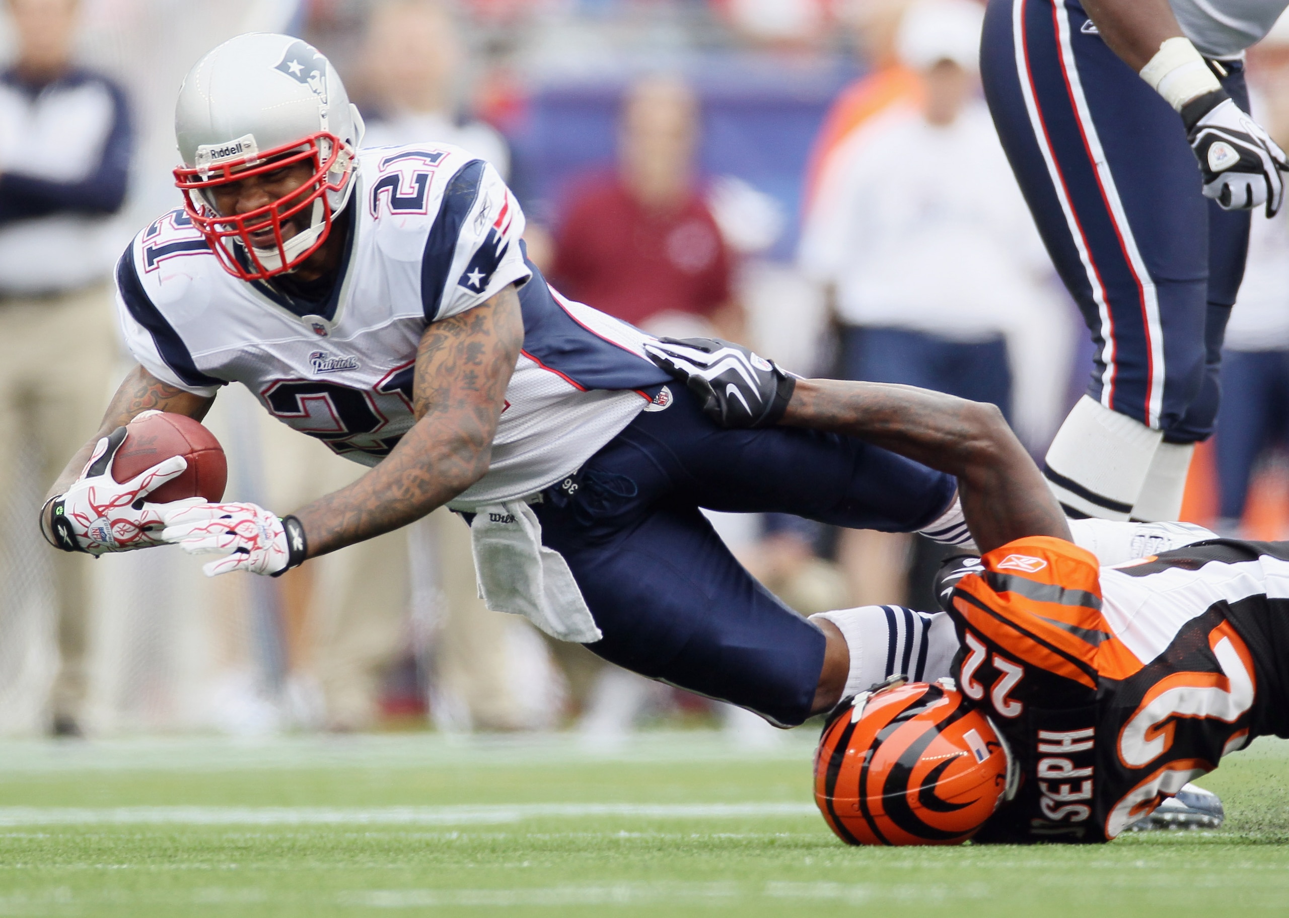 FOXBORO, MA - SEPTEMBER 12:  Fred Taylor #21 of the New England Patriots is tackled by Johnathan Joseph #22 of the Cincinnati Bengals during the NFL season opener on September 12, 2010 at Gillette Stadium in Foxboro, Massachusetts. The Patriots defeated t