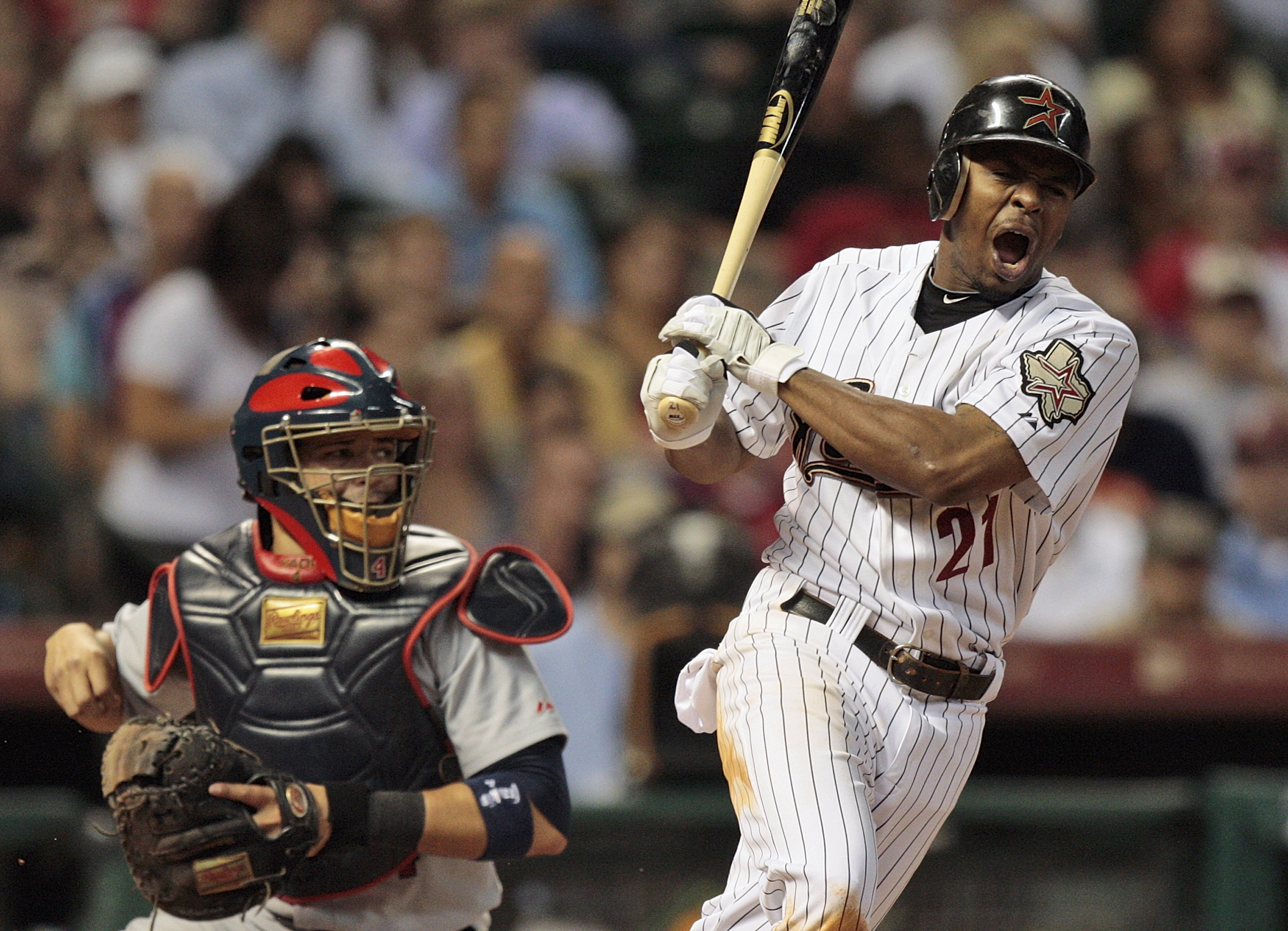 HOUSTON - AUGUST 31:  Michael Bourn #21 of the Houston Astros reacts after fouling a ball off his foot as catcher Yadier Molina #4 of the St. Louis Cardinals watches at Minute Maid Park on August 31, 2010 in Houston, Texas.  (Photo by Bob Levey/Getty Imag