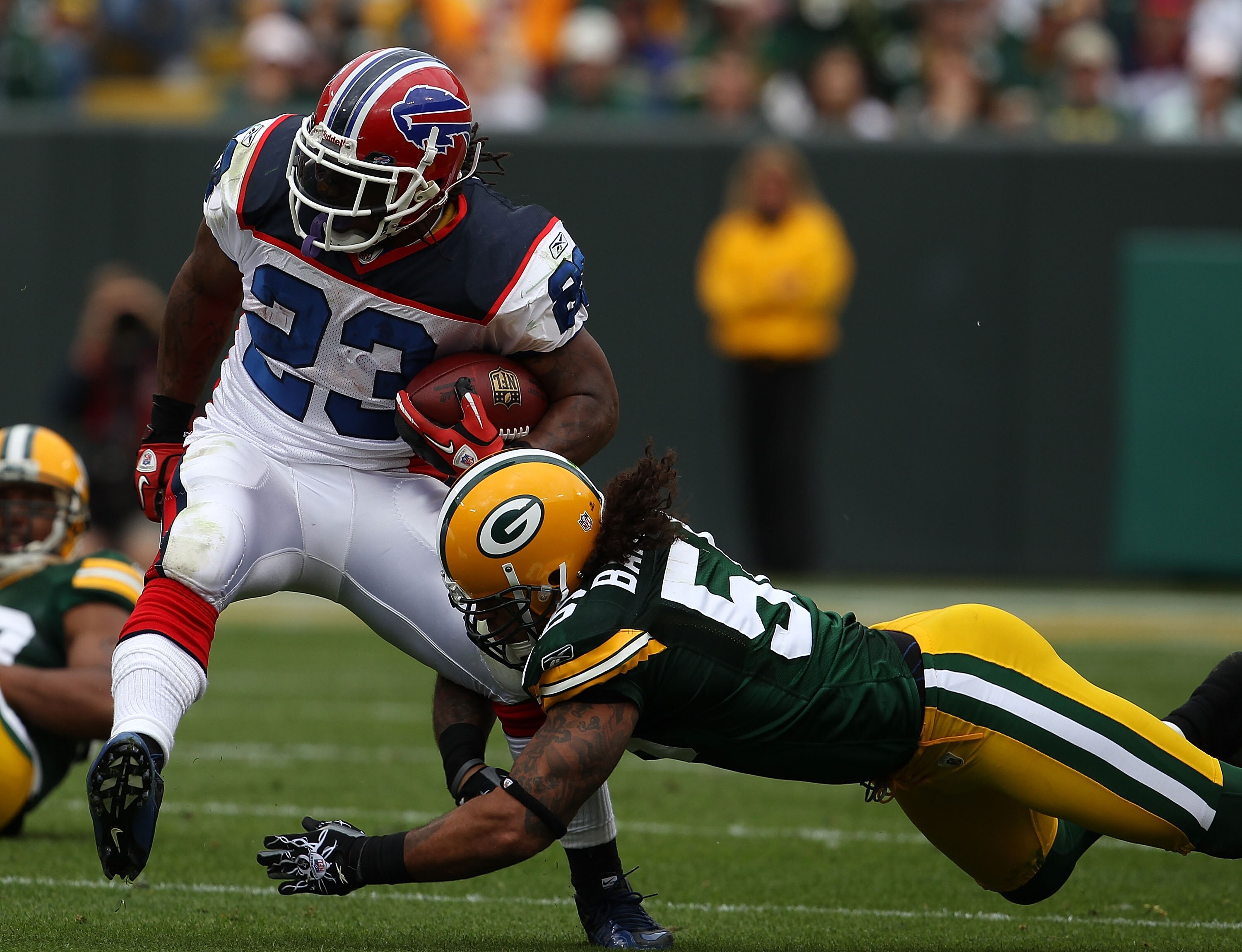GREEN BAY, WI - SEPTEMBER 19: Nick Barnett #56 of the Green Bay Packers tackles Marshawn Lynch #23 of the Buffalo Bills at Lambeau Field on September 19, 2010 in Green Bay, Wisconsin. The Packers defeated the Bills 34-7. (Photo by Jonathan Daniel/Getty Im