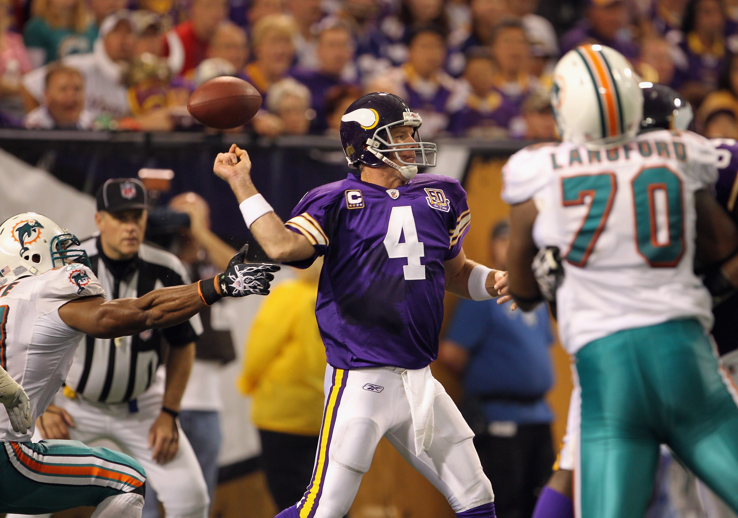 MINNEAPOLIS - SEPTEMBER 19:  Linebacker Cameron Wake #91 of the Miami Dolphins forces the ball loose as quarterback Brett Favre #4 of the Minnesota Vikings drops back to pass during the game on September 19, 2010 at Hubert H. Humphrey Metrodome in Minneap