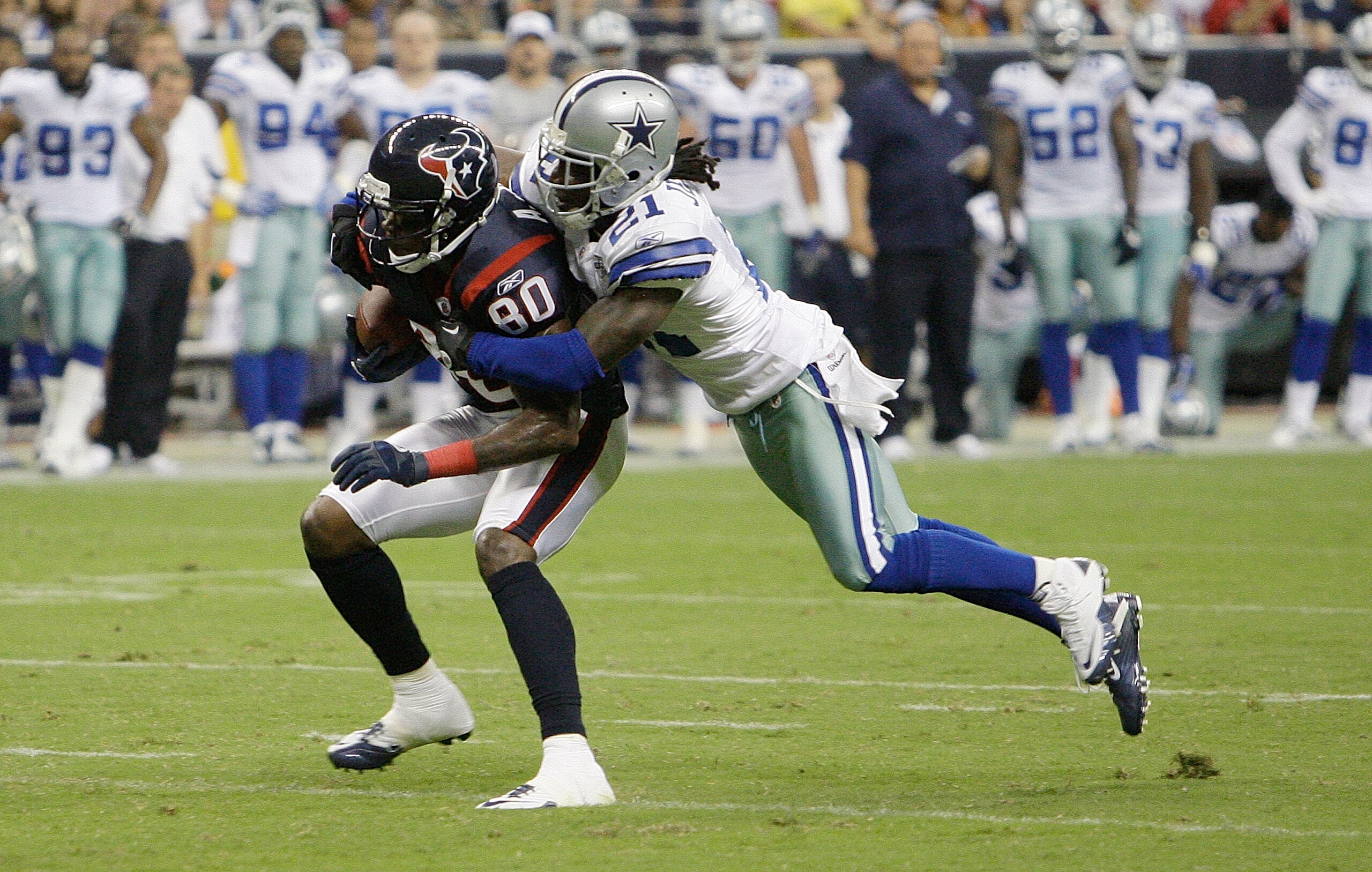 HOUSTON - AUGUST 28:  Wide receiver Andre Johnson #80 of the Houston Texans is tackled from behind by cornerback Mike Jenkins #21 of the Dallas Cowboys in the second quarter in a preseason game at Reliant Stadium on August 28, 2010 in Houston, Texas.  (Ph