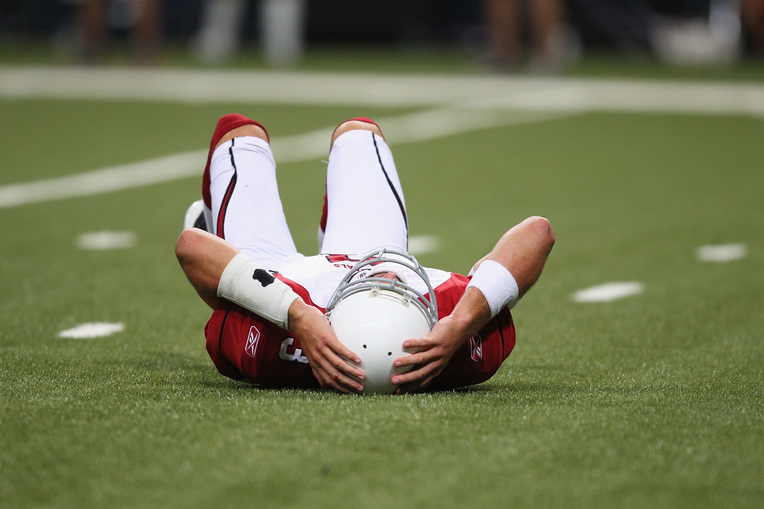 ST. LOUIS - SEPTEMBER 12: Derek Anderson #3 of the Arizona Cardinals lays on the ground after being sacked against the St. Louis Rams during the NFL season opener at the Edward Jones Dome on September 12, 2010 in St. Louis, Missouri.  The Cardinals beat t