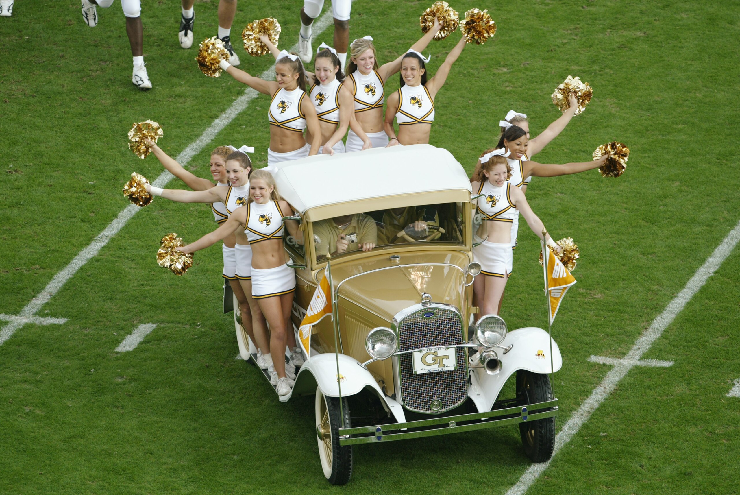 ATLANTA - NOVEMBER 20:  Georgia Tech Cheerleaders ride the Rambling Wreck - a 1930 Ford Cabriolet Sport Coupe - during an intermission in the game between the Georgia Tech Yellow Jackets and the University of Virginia Cavaliers at Bobby Dodd Stadium on No