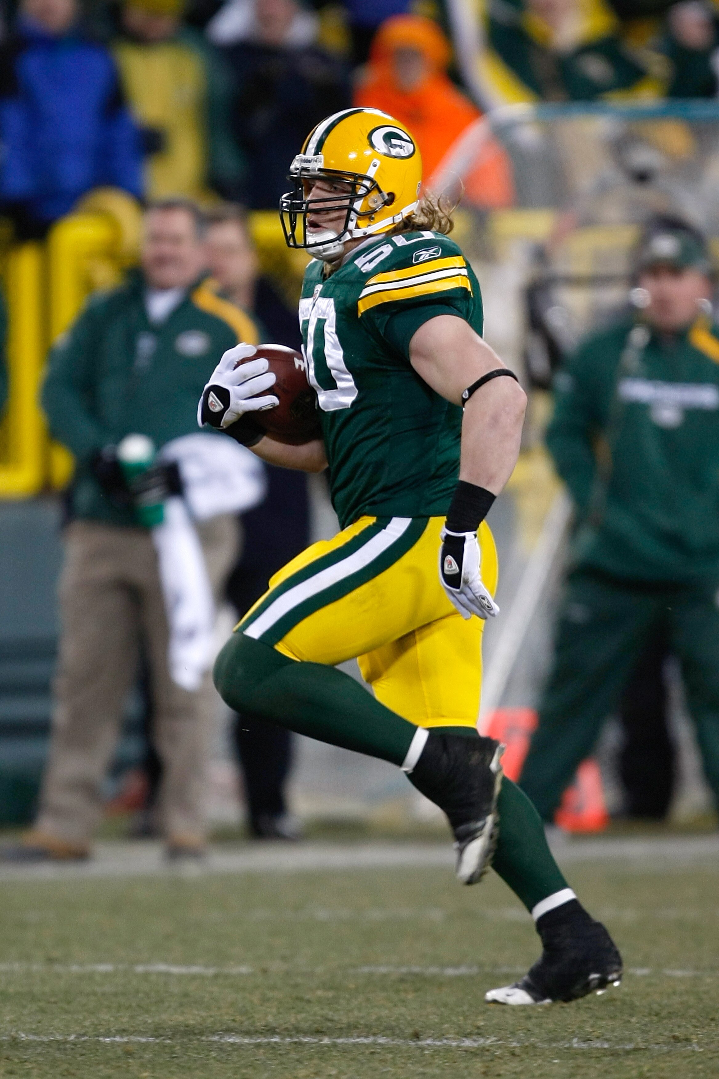 GREEN BAY, WI - DECEMBER 7: Linebacker A.J. Hawk #50 of the Green Bay Packers runs with the football after an interception against the Baltimore Ravens at Lambeau Field on December 7, 2009 in Green Bay, Wisconsin. The Packers defeated the Ravens 27-17. (P