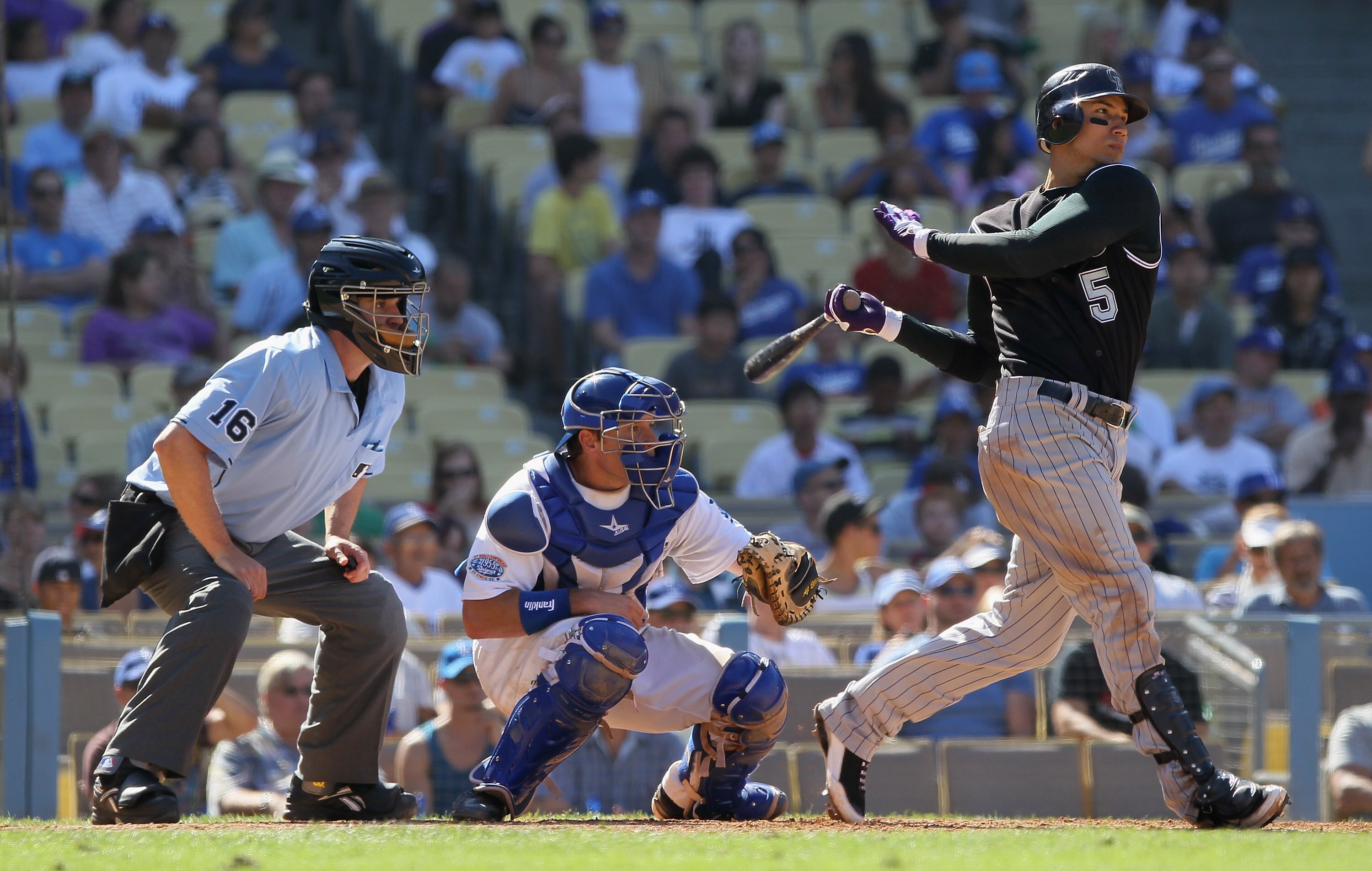 LOS ANGELES, CA - SEPTEMBER 18:  Carlos Gonzalez #5 of the Colorado Rockies hits a base hit in the eighth inning against the Los Angeles Dodgers at Dodger Stadium on September 18, 2010 in Los Angeles, California. The Rockies defeated the Dodgers 12-2.  (P