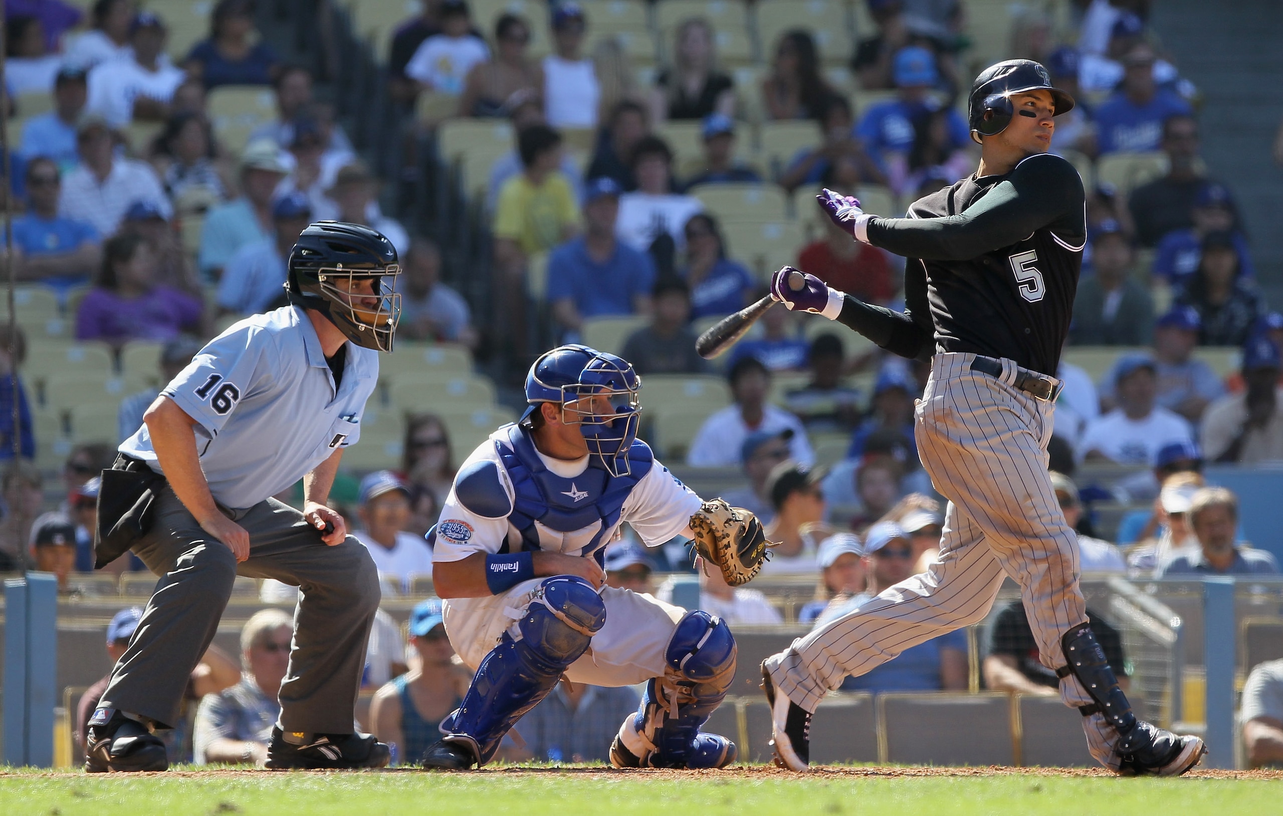 LOS ANGELES, CA - SEPTEMBER 18:  Carlos Gonzalez #5 of the Colorado Rockies hits a base hit in the eighth inning against the Los Angeles Dodgers at Dodger Stadium on September 18, 2010 in Los Angeles, California. The Rockies defeated the Dodgers 12-2.  (P
