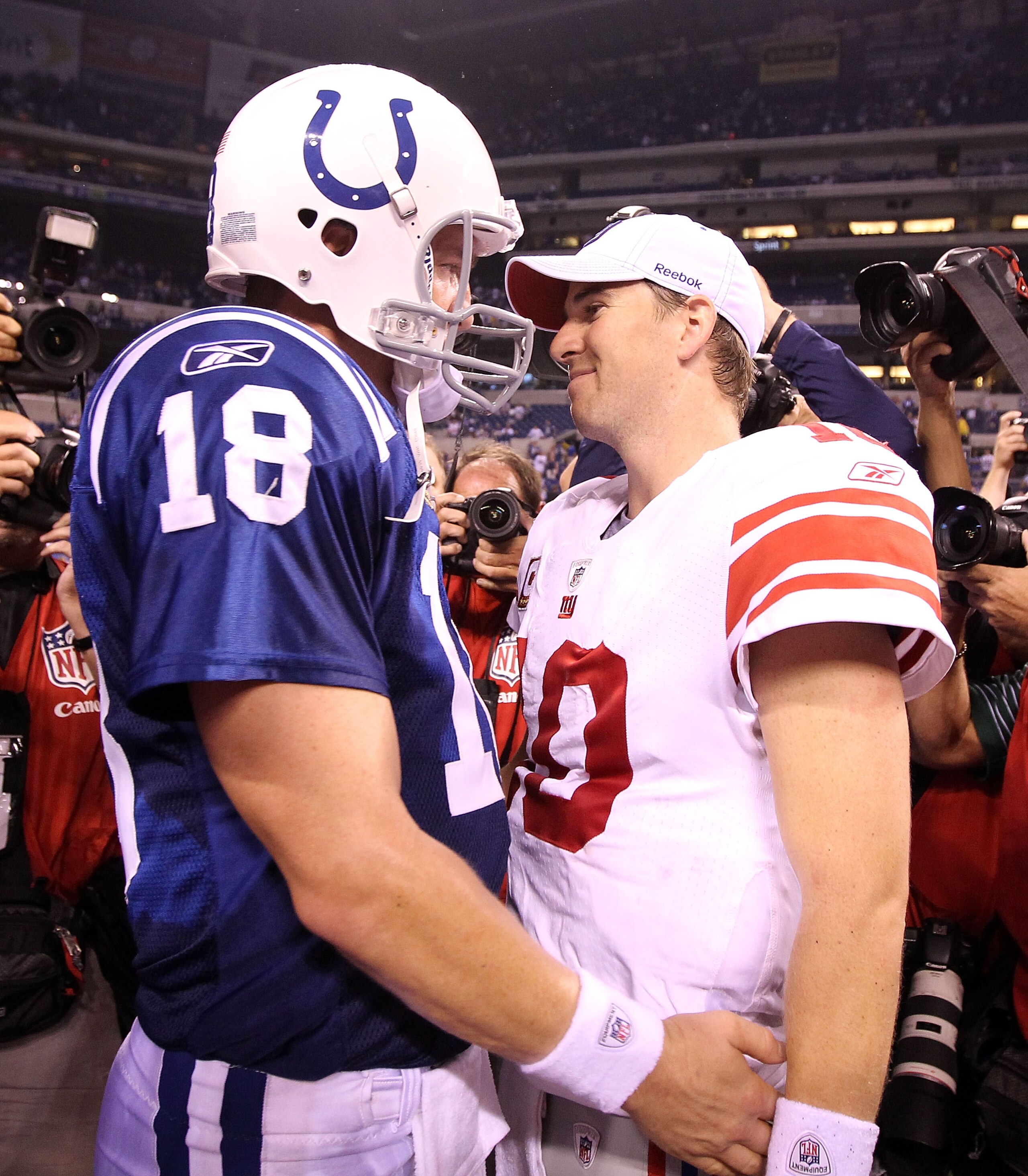 INDIANAPOLIS - SEPTEMBER 19:  Eli Manning #10 of the New York Giants and Peyton Manning #18 of the Indianapolis Colts embrace following the Colts 38-14 win at Lucas Oil Stadium on September 19, 2010 in Indianapolis, Indiana.  (Photo by Andy Lyons/Getty Im