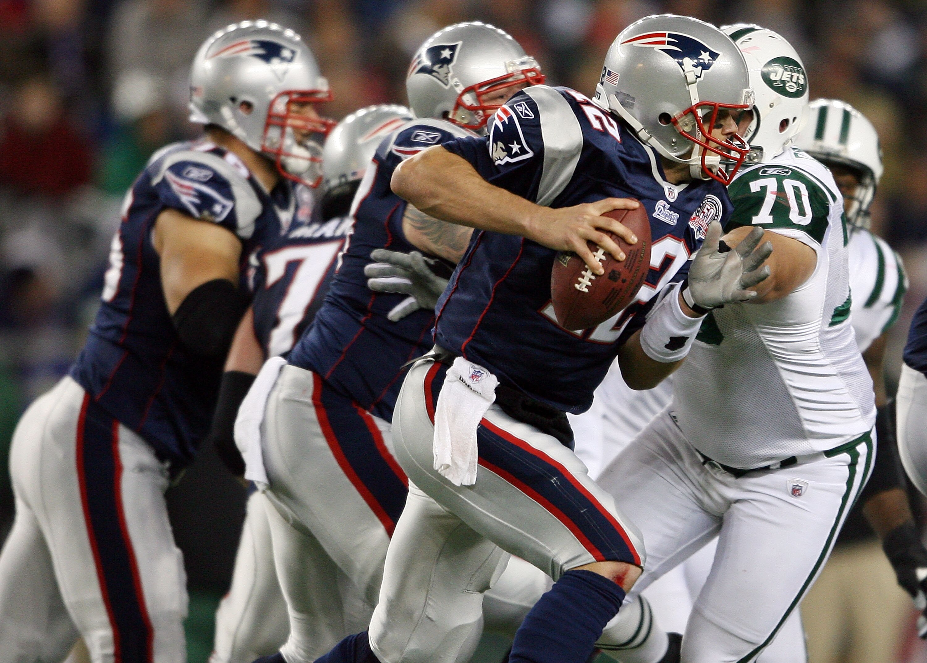 FOXBORO, MA - NOVEMBER 22:  Tom Brady #12 of the New England Patriots scrambles as Mike DeVito #70 of the New York Jets pressures on November 22, 2009 at Gillette Stadium in Foxboro, Massachusetts. The Patriots defeated the Jets 31-14.  (Photo by Elsa/Get