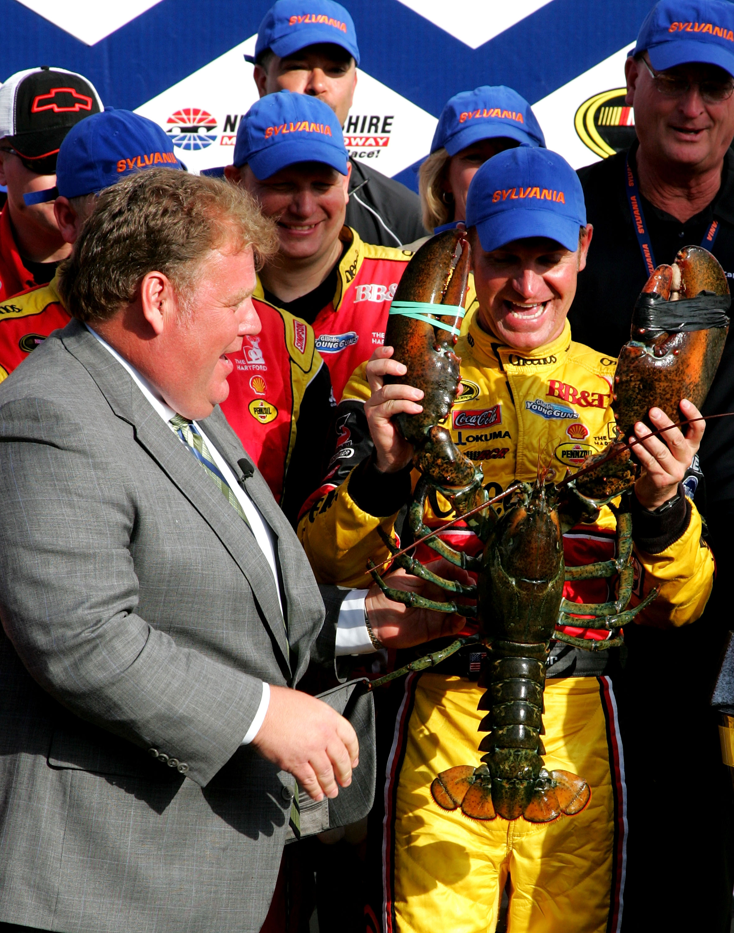 LOUDON, NH - SEPTEMBER 19:  Clint Bowyer, driver of the #33 Cheerios / Hamburger Helper Chevrolet recieves a huge lobster during Victory Lane ceremonies at the NASCAR Sprint Cup Series Sylvania 300 at New Hampshire Motor Speedway on September 19, 2010 in
