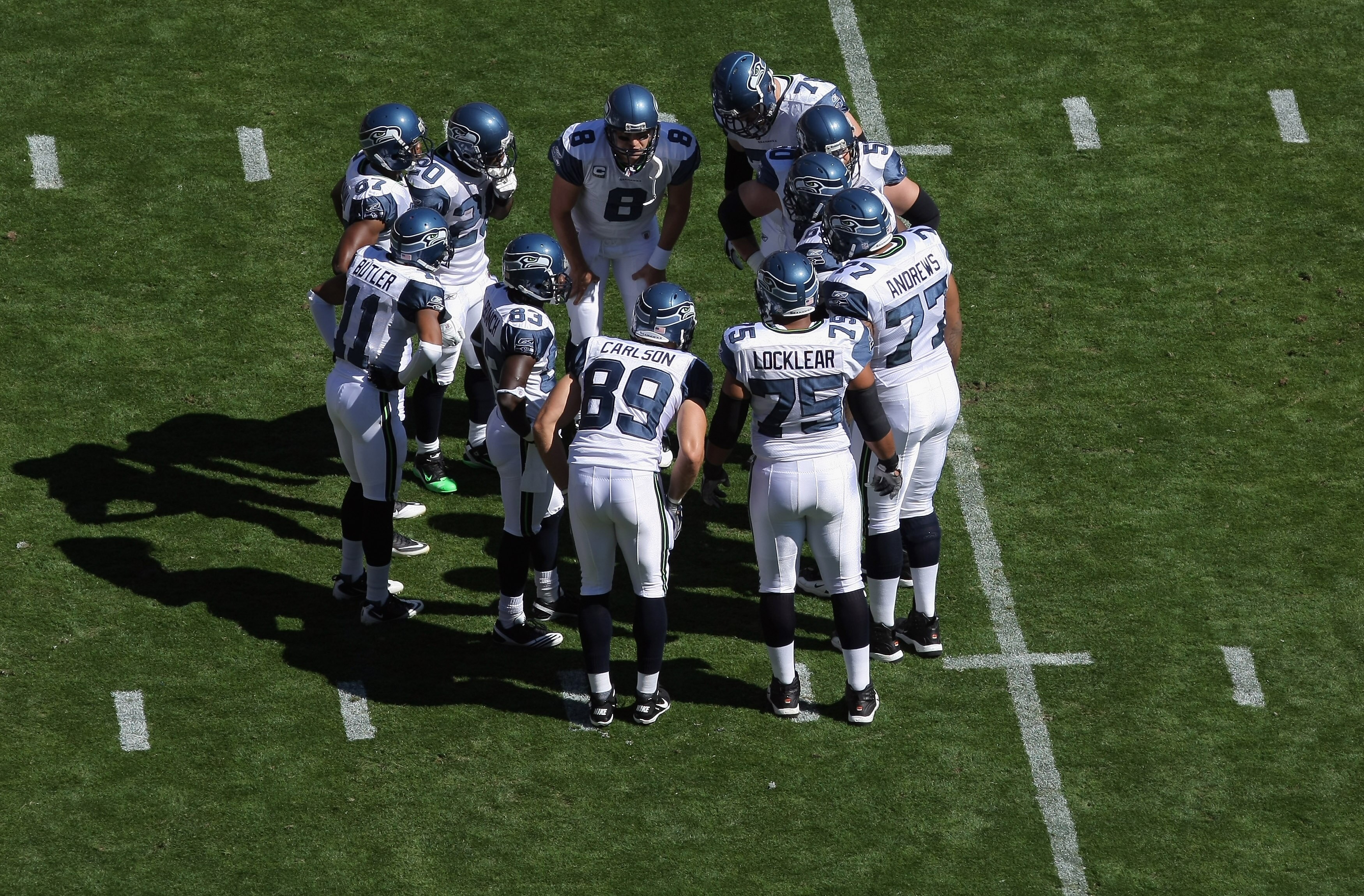 DENVER - SEPTEMBER 19:  Quarterback Matt Hasselbeck #8 of the Seattle Seahawks runs the offensive huddle against the Denver Broncos at INVESCO Field at Mile High on September 19, 2010 in Denver, Colorado. The Broncos defeated the Seahawks 31-14.  (Photo b