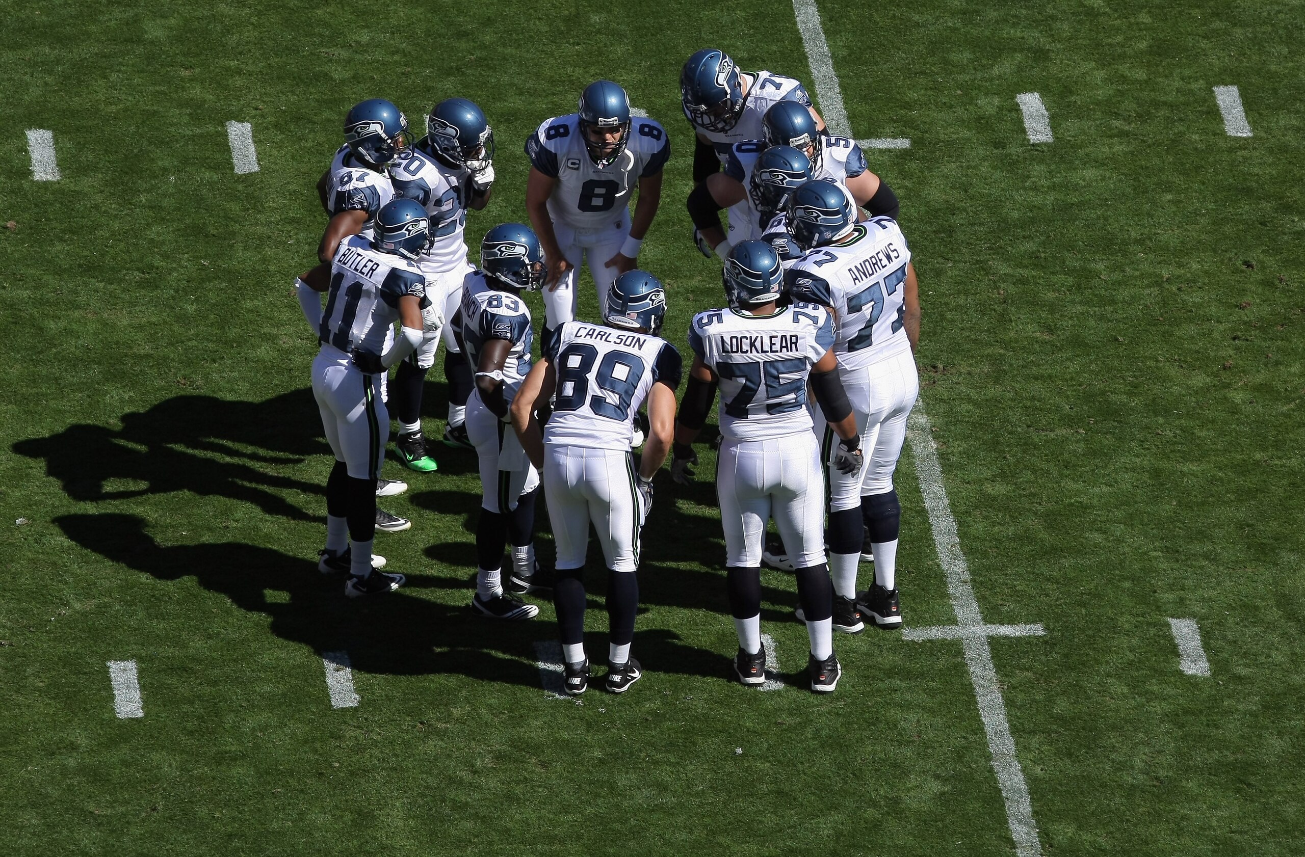 DENVER - SEPTEMBER 19:  Quarterback Matt Hasselbeck #8 of the Seattle Seahawks runs the offensive huddle against the Denver Broncos at INVESCO Field at Mile High on September 19, 2010 in Denver, Colorado. The Broncos defeated the Seahawks 31-14.  (Photo b