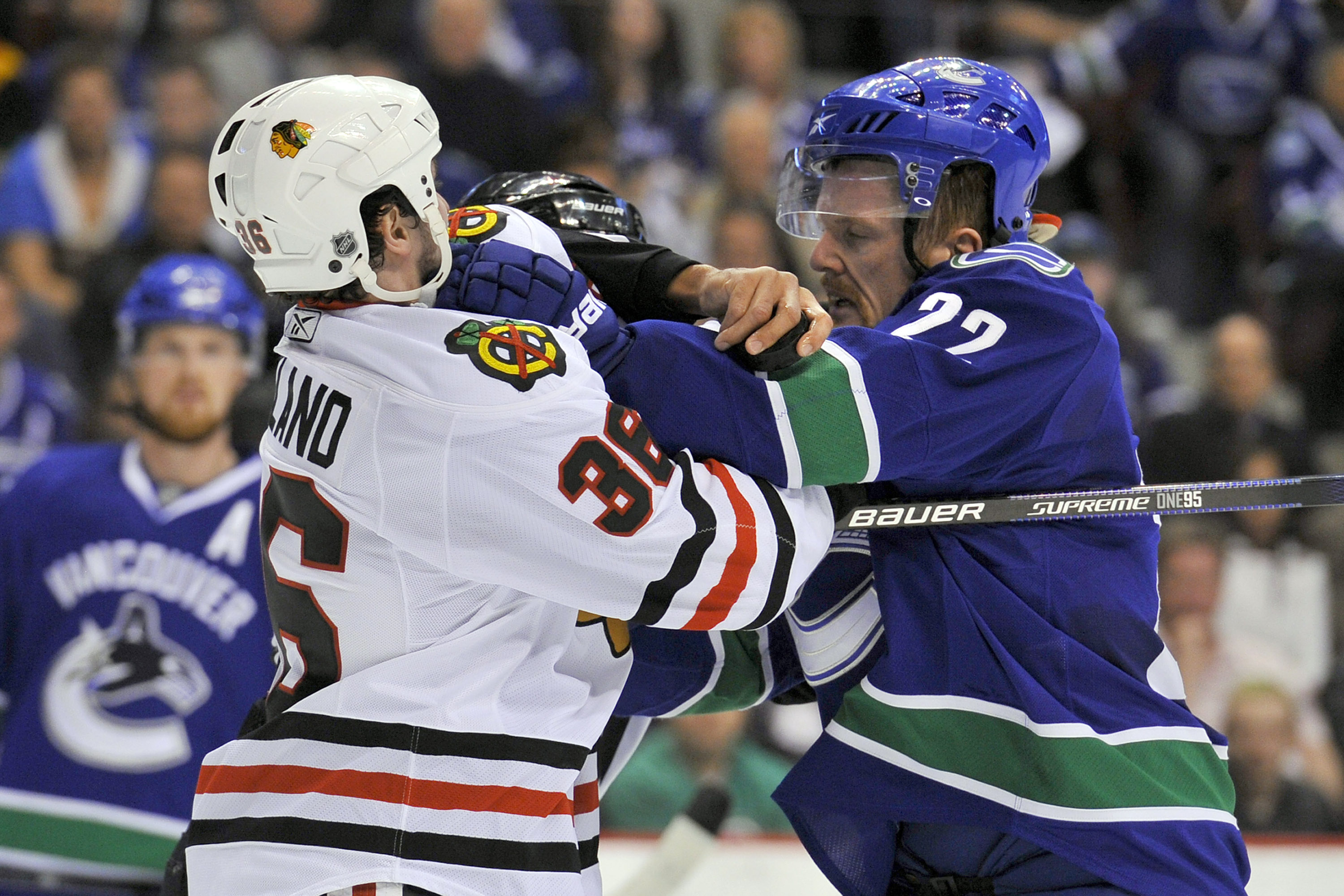 VANCOUVER, CANADA - MAY 5:  Daniel Sedin #22 of the Vancouver Canucks and Dave Bolland #36 of the Chicago Blackhawks tussle prior to a face-off during the first period in Game Three of the Western Conference Semifinals during the 2010 NHL Stanley Cup Play