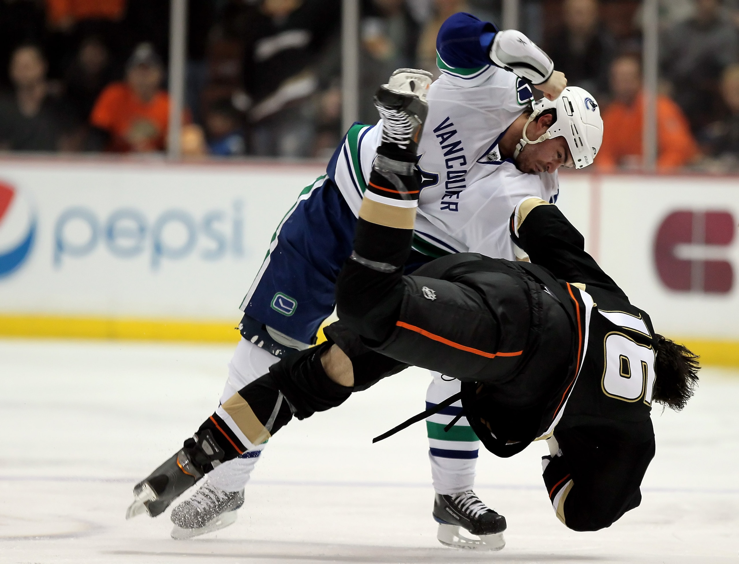 ANAHEIM, CA - APRIL 02:  Darcy Hordichuk #24 of the Vancouver Canucks throws George Parros #16 of the Anaheim Ducks to the ground during a fight in the second period at the Honda Center on April 2, 2010 in Anaheim, California. The Canucks defeated the Duc