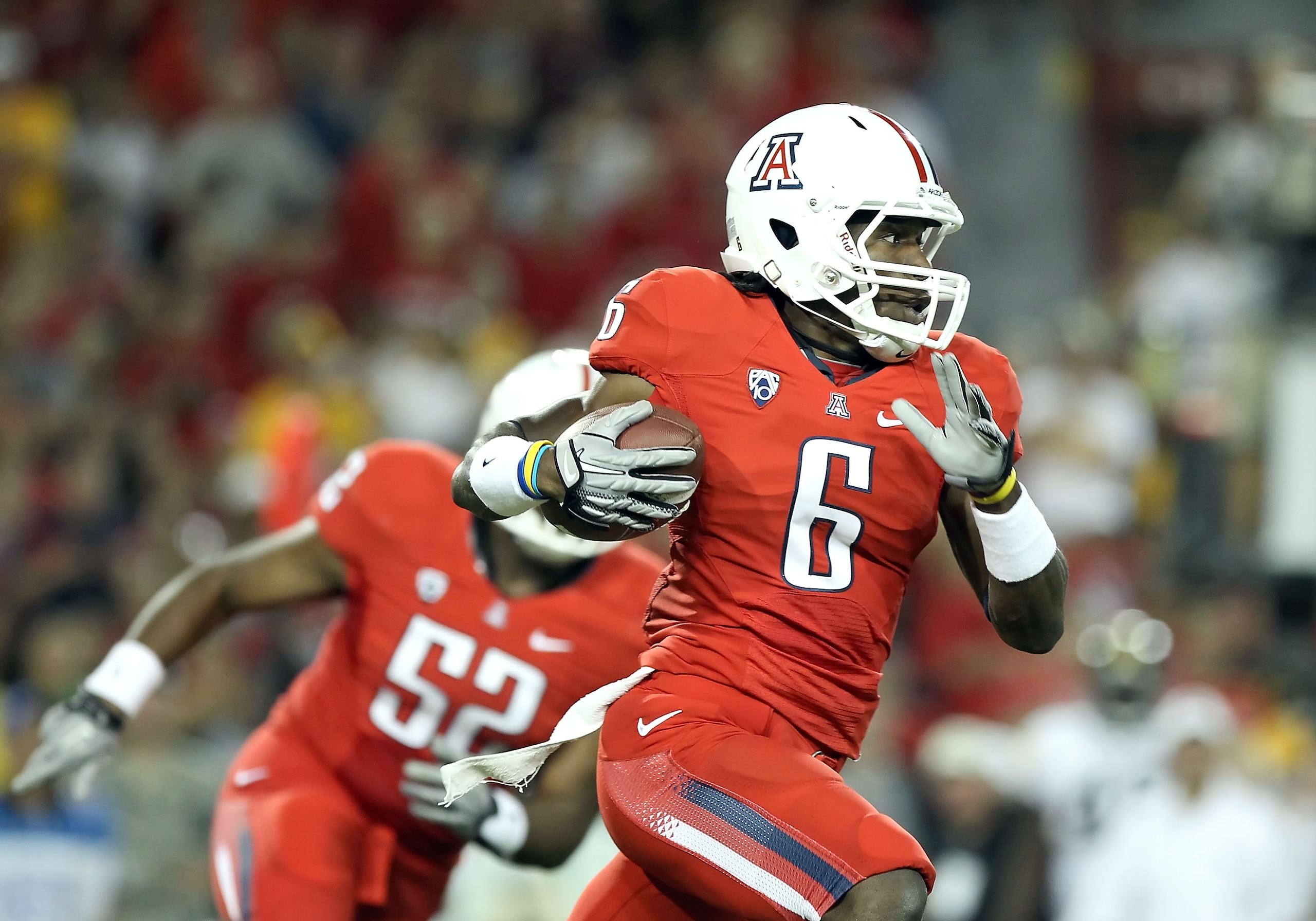 TUCSON, AZ - SEPTEMBER 18:  Wide receiver Travis Cobb #6 of the Arizona Wildcats returns a kick off for a 100 yard touchdown against the Iowa Hawkeyes during the second quarter of the college football game at Arizona Stadium on September 18, 2010 in Tucso