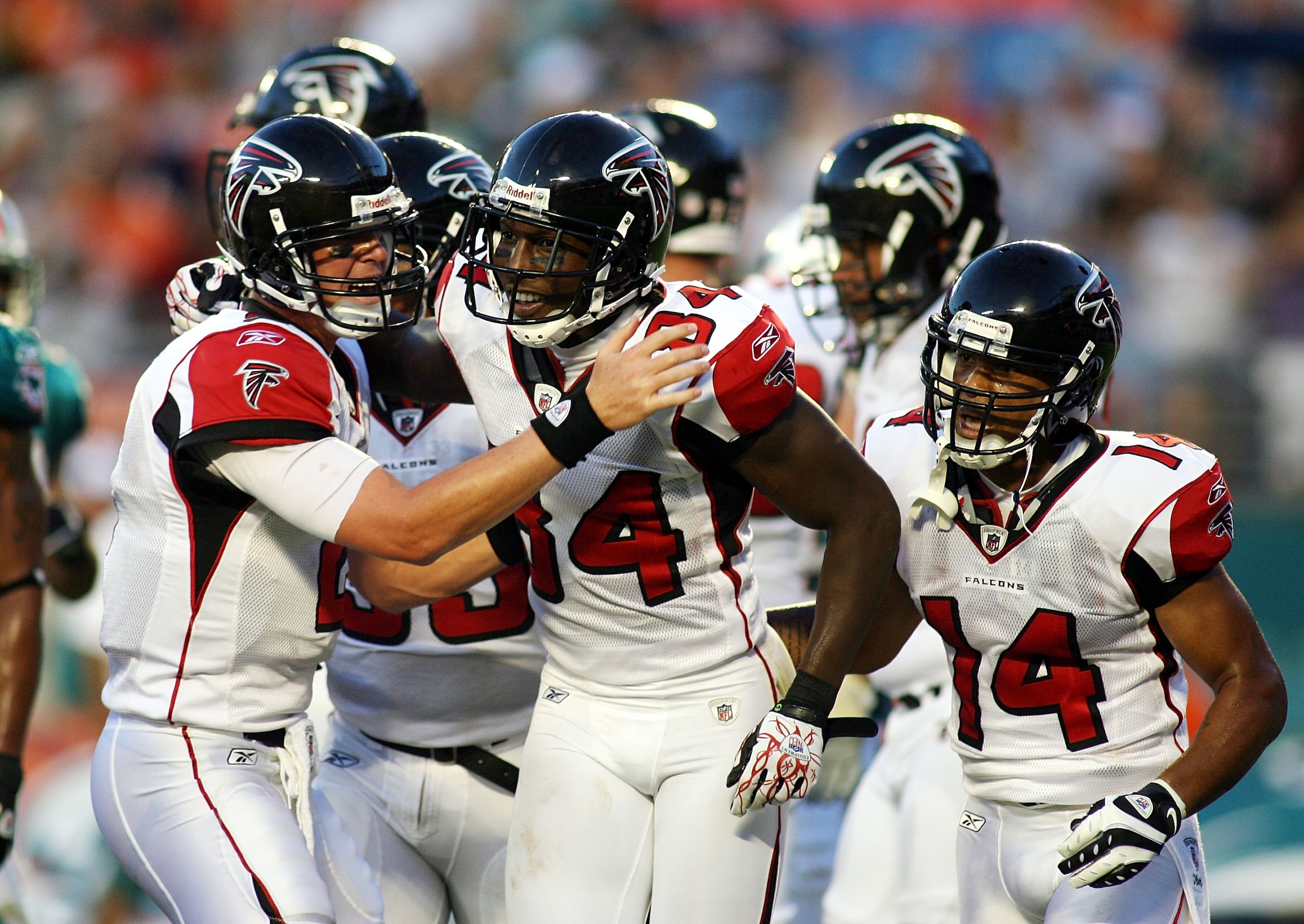 MIAMI - AUGUST 27:  Quarterback Matt Ryan #2  (L) and wide reciever Roddy White #84 (C) of the Atlanta Falcons celebrate a touchdown catch by White against the Miami Dolphins during their preseason game at Sun Life Stadium on August 27, 2010 in Miami, Flo