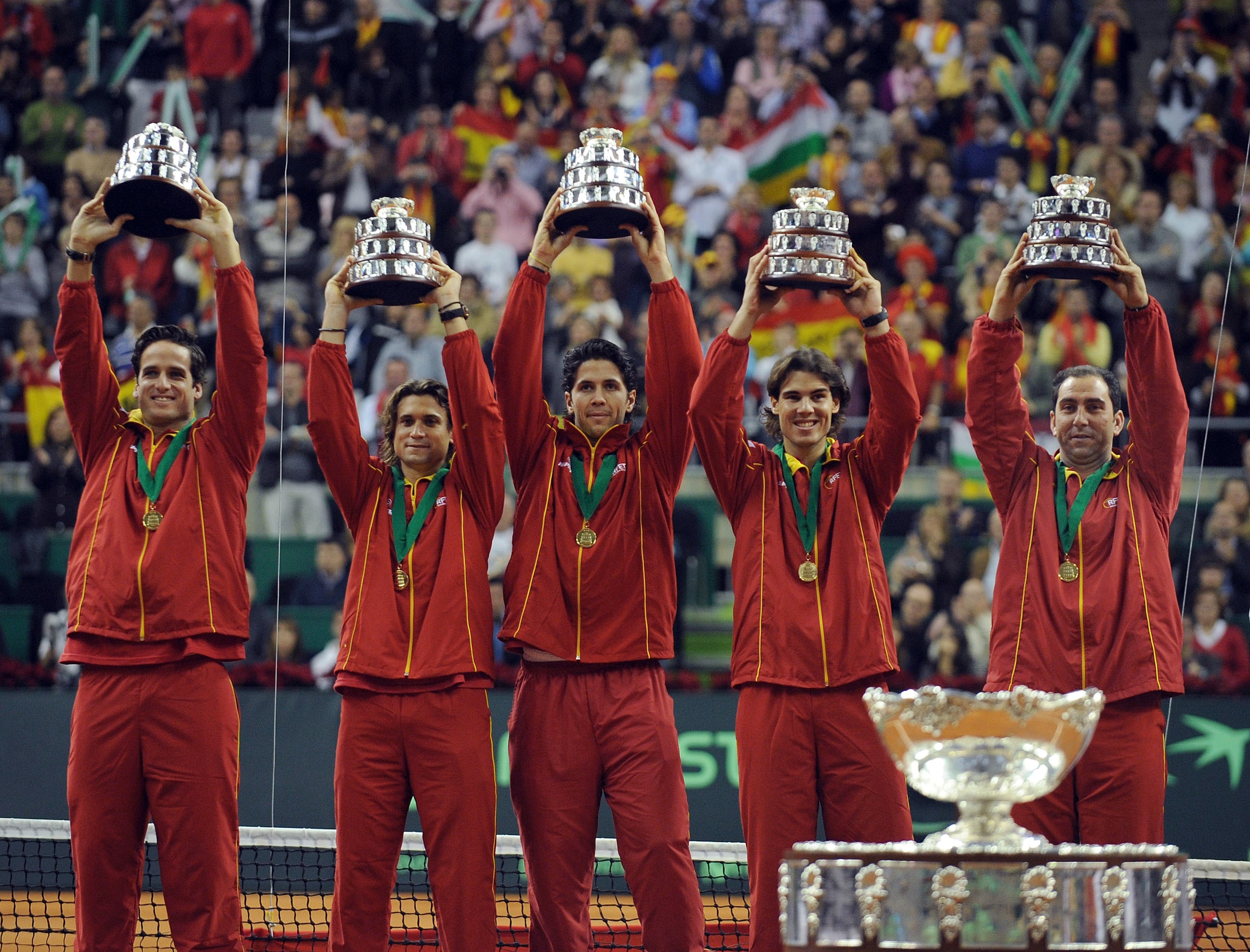 BARCELONA, SPAIN - DECEMBER 06:  Spanish players Feliciano Lopez (L), David Ferrer,  Fernando Verdasco (C) Rafael Nadal (2R) and team captain Albert Costa celebrate with the Davis Cup trophy at the end of the final match between Spain and Czech Republic a