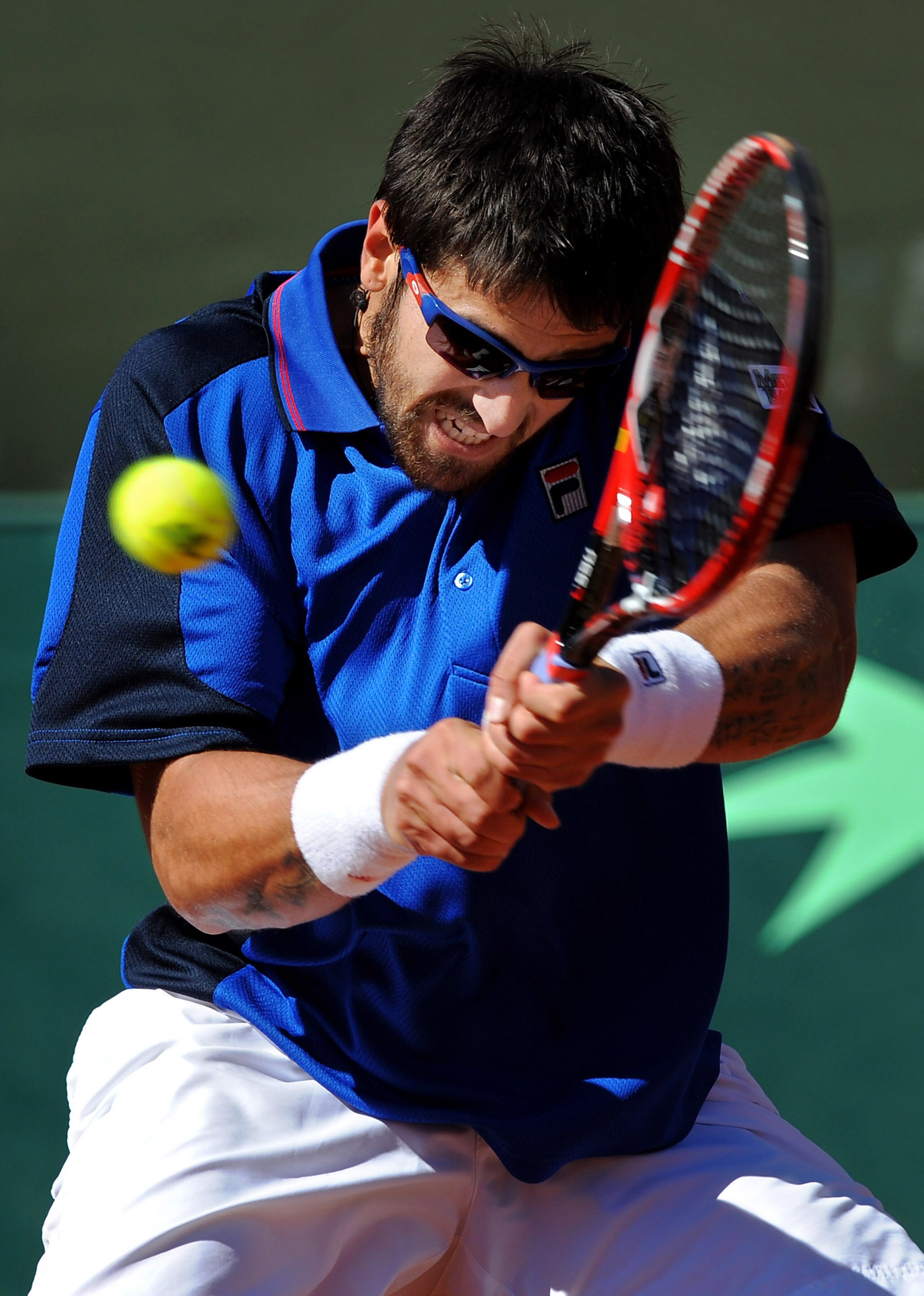 BENIDORM, SPAIN - MARCH 07:  Janko Tipsarevic of Serbia returns a forehand to Rafael Nadal of Spain during day one of the Davis Cup World Group first round tie between Spain and Serbia at the Parque Tematico Terra Mitica on March 7, 2009 in Benidorm, Spai