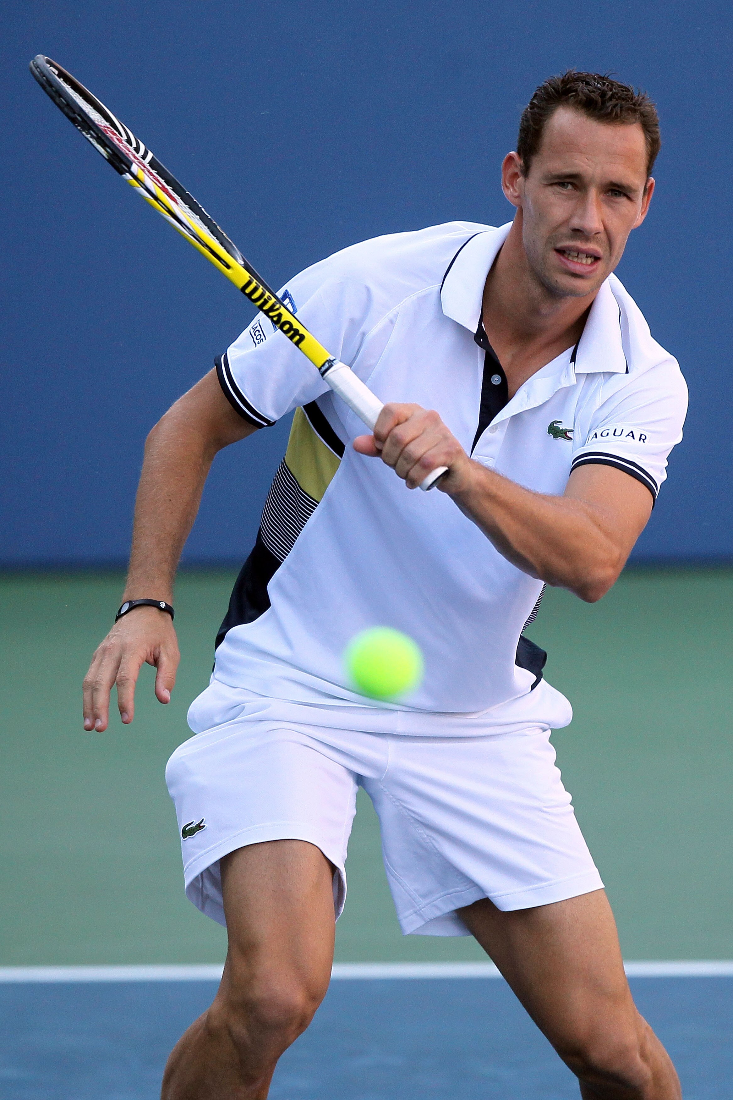 NEW YORK - SEPTEMBER 05:  Michael Llodra of France returns a shot against Tommy Robredo of Spain during the men's singles match on day seven of the 2010 U.S. Open at the USTA Billie Jean King National Tennis Center on September 5, 2010 in the Flushing nei