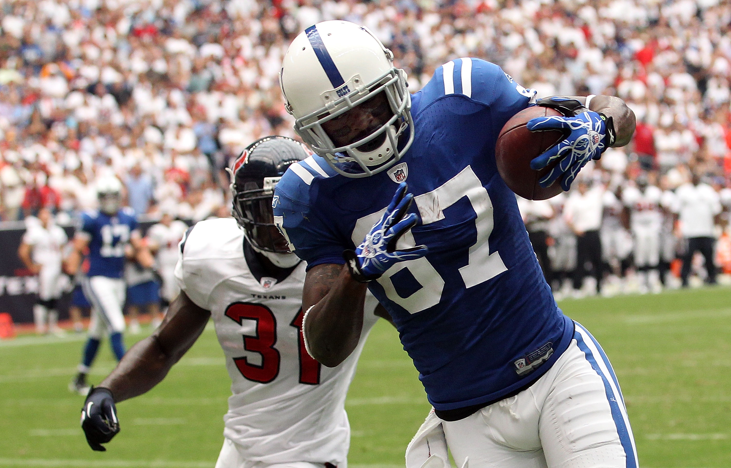 HOUSTON - SEPTEMBER 12:  Wide receiver Reggie Wayne #87 of the Indianapolis Colts makes a touchdown pass reception in front of Bernard Pollard #31 of the Houston Texans during the NFL season opener at Reliant Stadium on September 12, 2010 in Houston, Texa