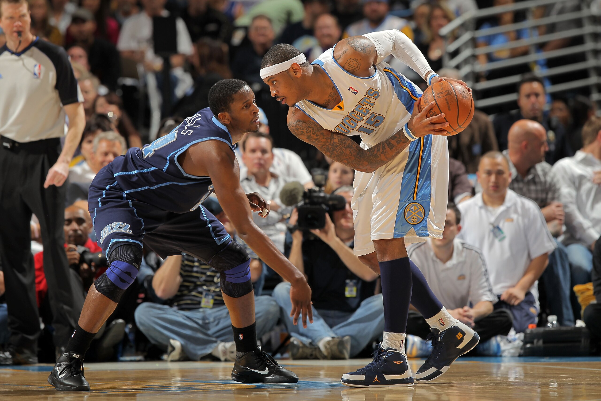 DENVER - APRIL 28:  Carmelo Anthony #15 of the Denver Nuggets as C.J. Miles #34 of the Utah Jazz defends in Game Five of the Western Conference Quarterfinals of the 2010 NBA Playoffs at the Pepsi Center on April 28, 2010 in Denver, Colorado. The Nuggets d