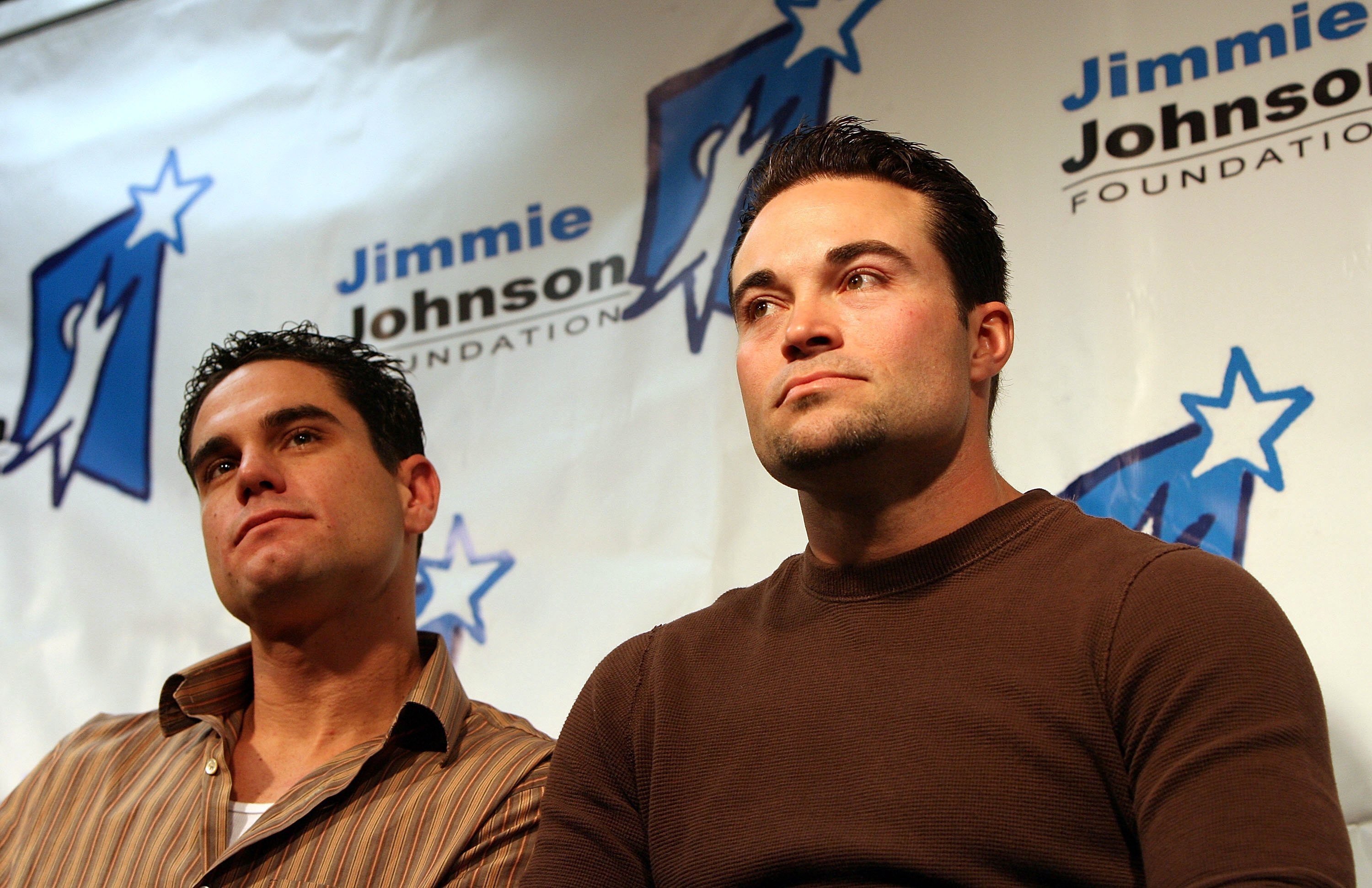 DAYTONA BEACH, FL - FEBRUARY 11:  Marcus Giles and Mike Hampton of the Atlanta Braves listen as Jimmie Johnson announces the creation of the 'Jimmie Johnson Foundation' February 11, 2006 at Daytona International Speedway in Daytona Beach, Florida.  (Photo