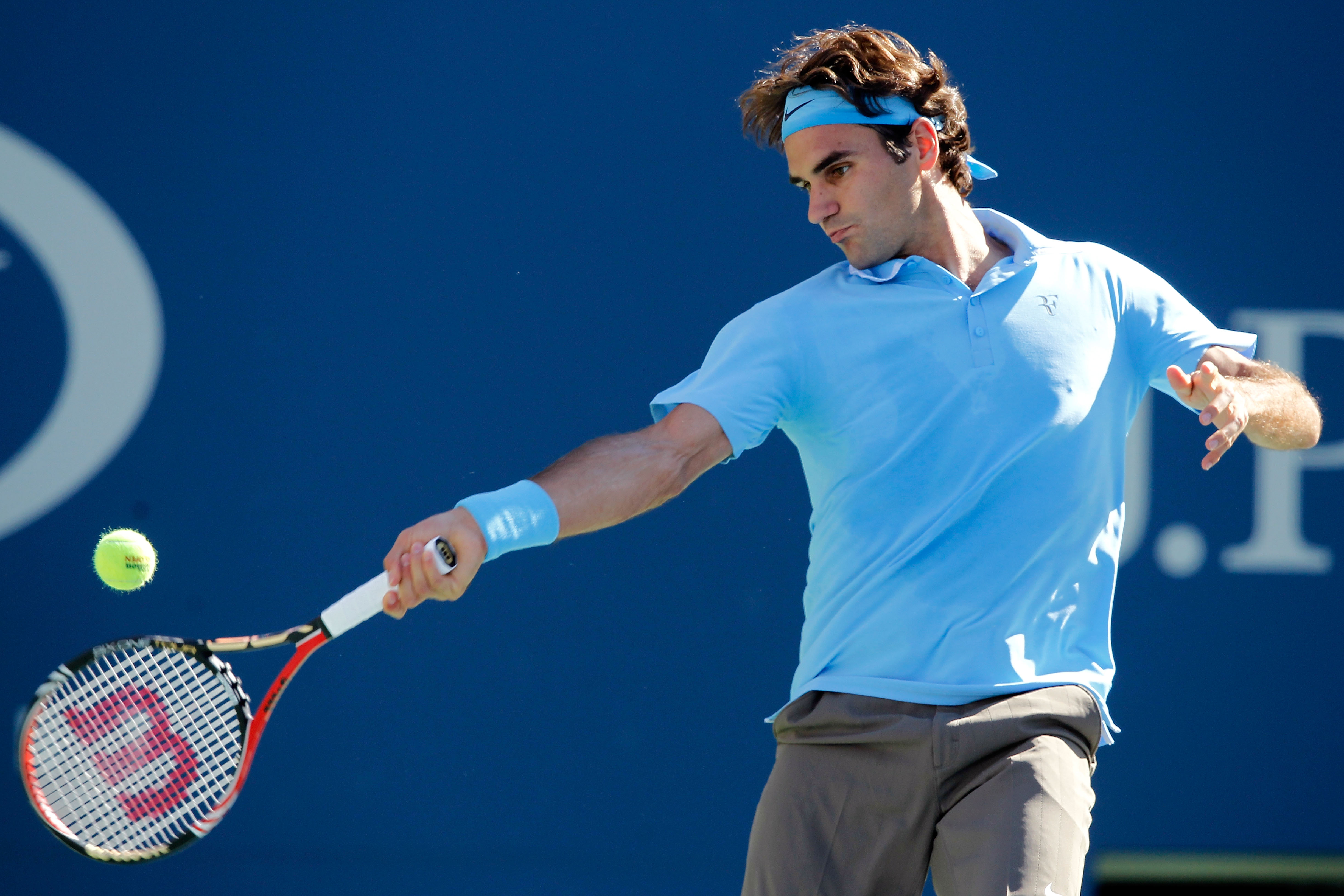 NEW YORK - SEPTEMBER 11:  Roger Federer of Switzerland returns a shot against Novak Djokovic of Serbia during his men's singles semifinal match on day thirteen of the 2010 U.S. Open at the USTA Billie Jean King National Tennis Center on September 11, 2010