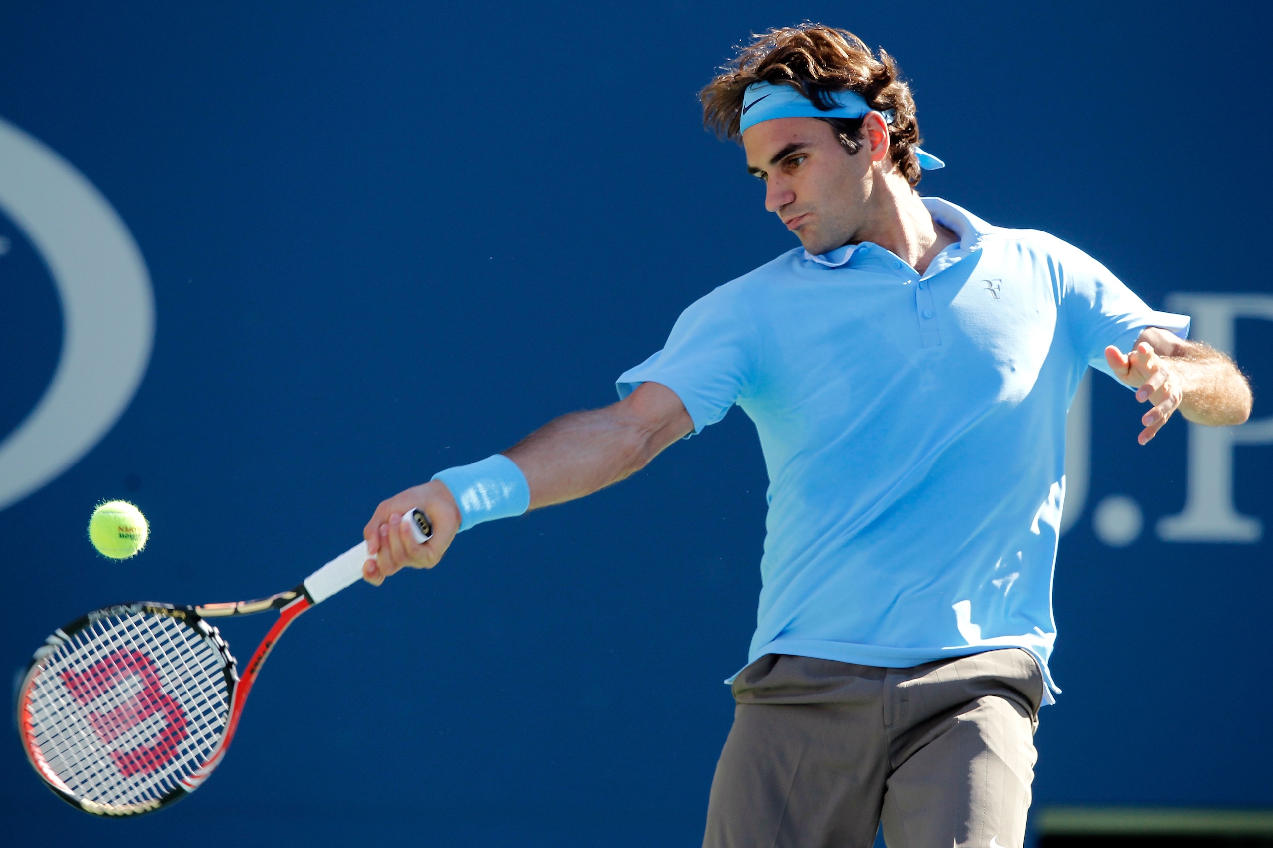 NEW YORK - SEPTEMBER 11:  Roger Federer of Switzerland returns a shot against Novak Djokovic of Serbia during his men's singles semifinal match on day thirteen of the 2010 U.S. Open at the USTA Billie Jean King National Tennis Center on September 11, 2010