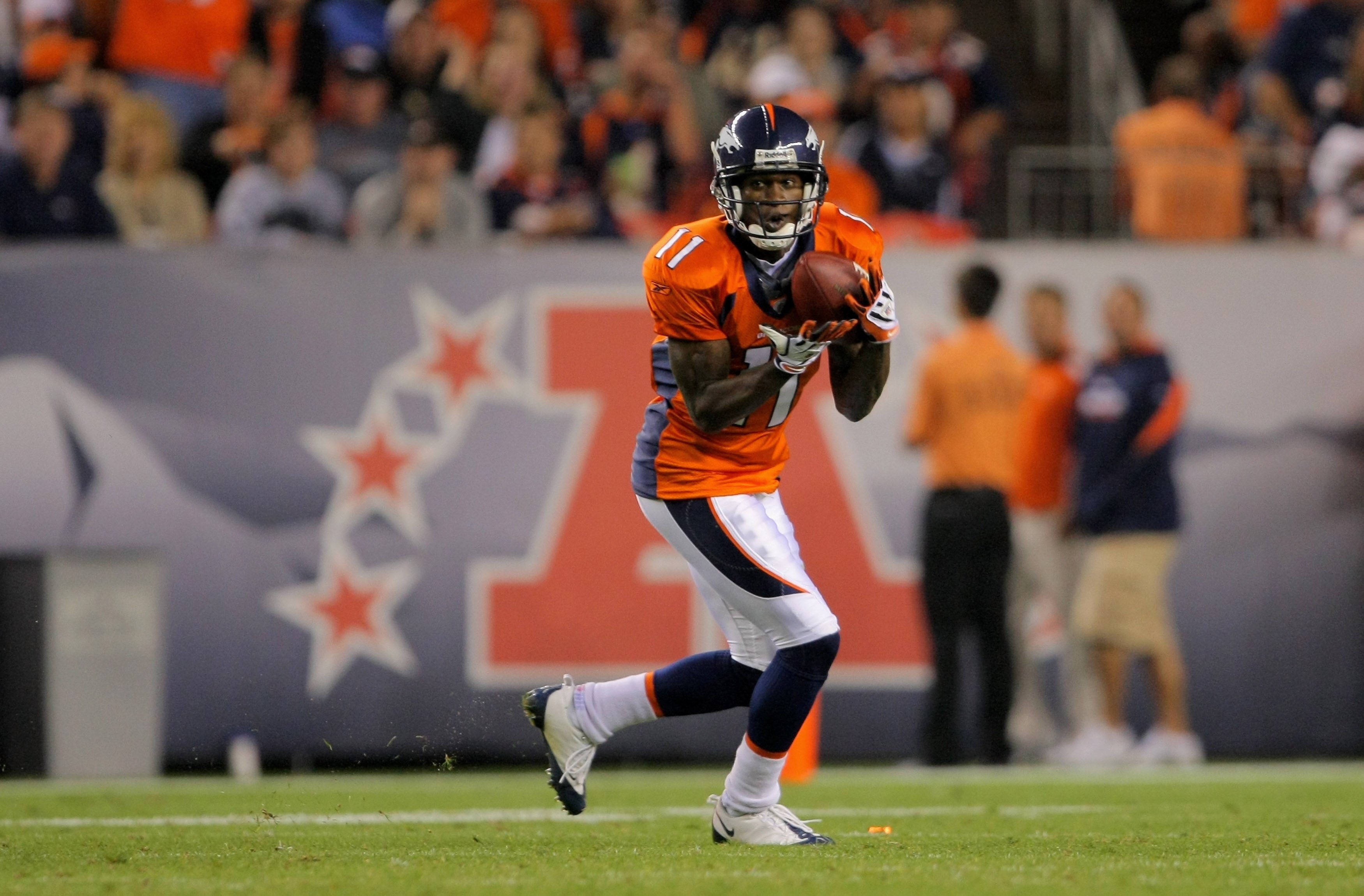 DENVER - AUGUST 30:  Wide reciever Kenny McKinley #11 of the Denver Broncos makes a reception against the Chicago Bears during preseason NFL action at INVESCO Field at Mile High on August 30, 2009 in Denver, Colorado. The Bears defeated the Broncos 27-17.